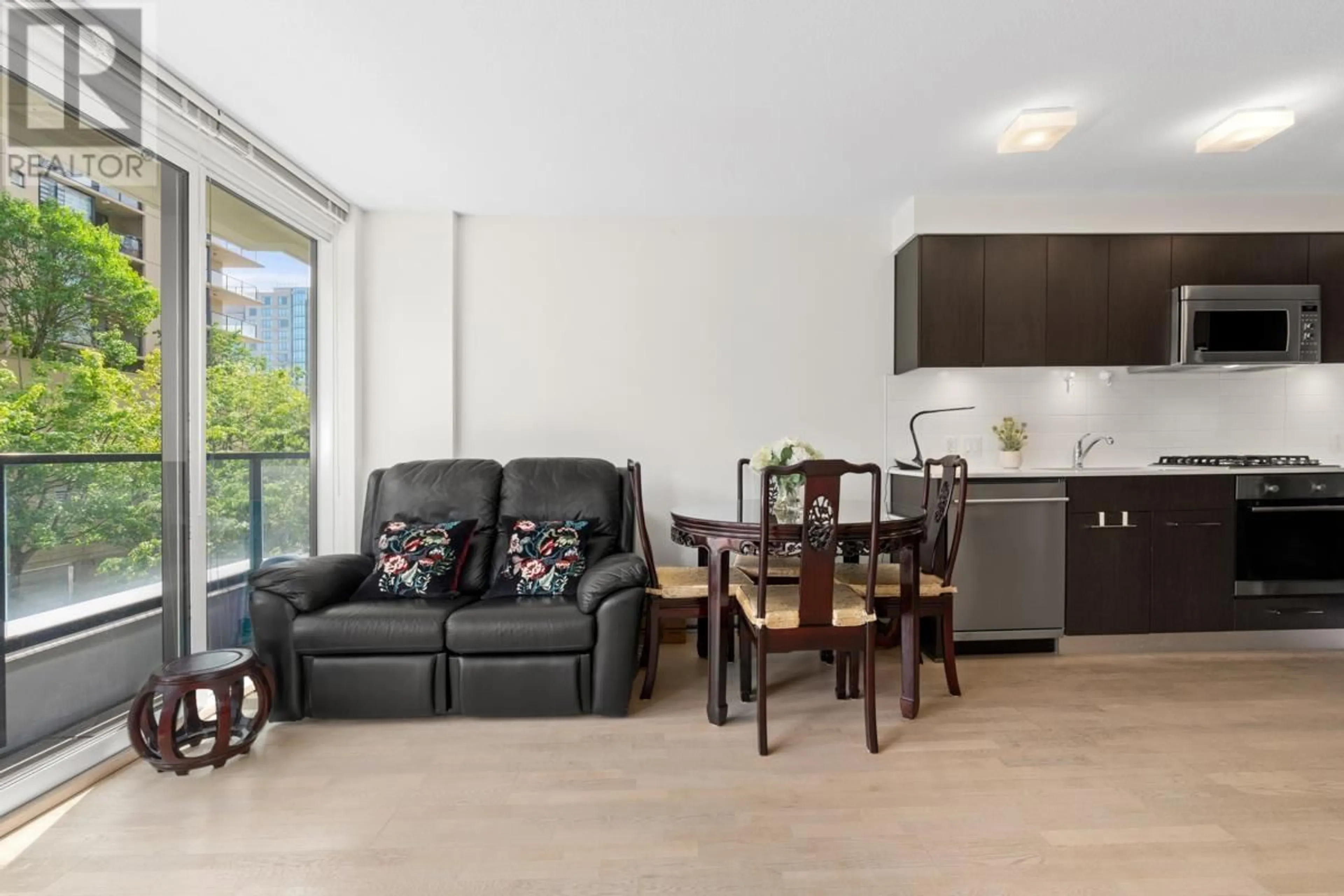 Living room with furniture, wood/laminate floor for 309 - 7733 FIRBRIDGE WAY, Richmond British Columbia V6X0M7