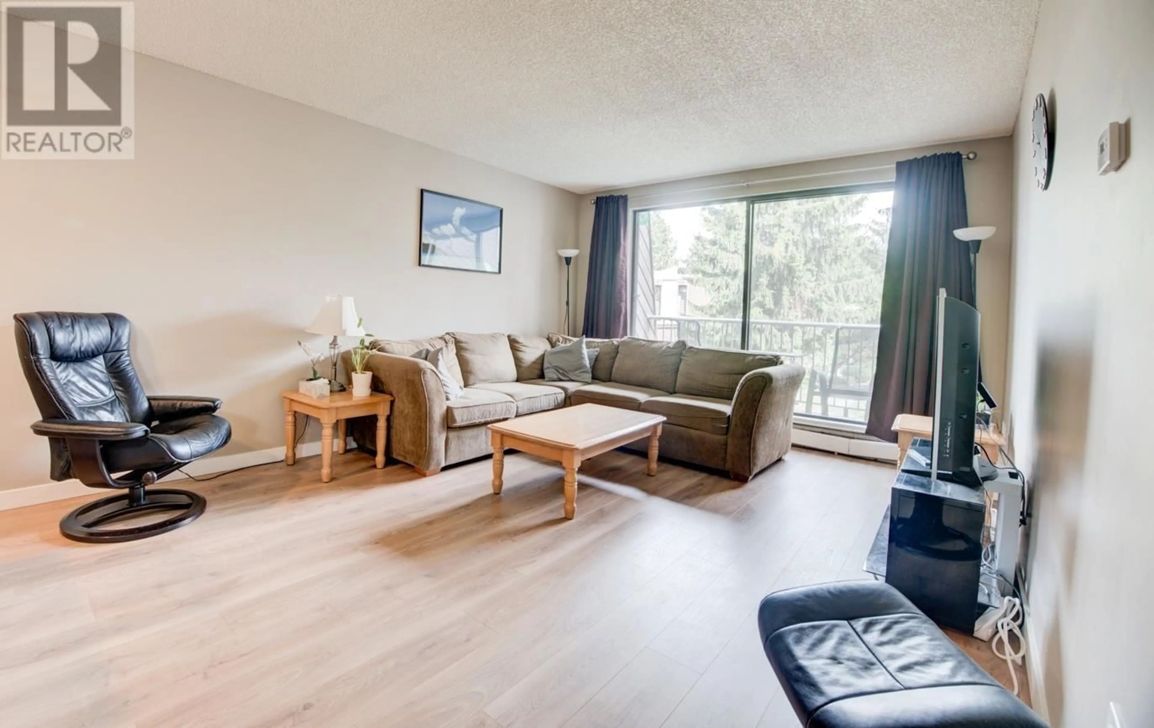 Living room with furniture, wood/laminate floor for 201 - 3921 CARRIGAN COURT, Burnaby British Columbia V3N4J7