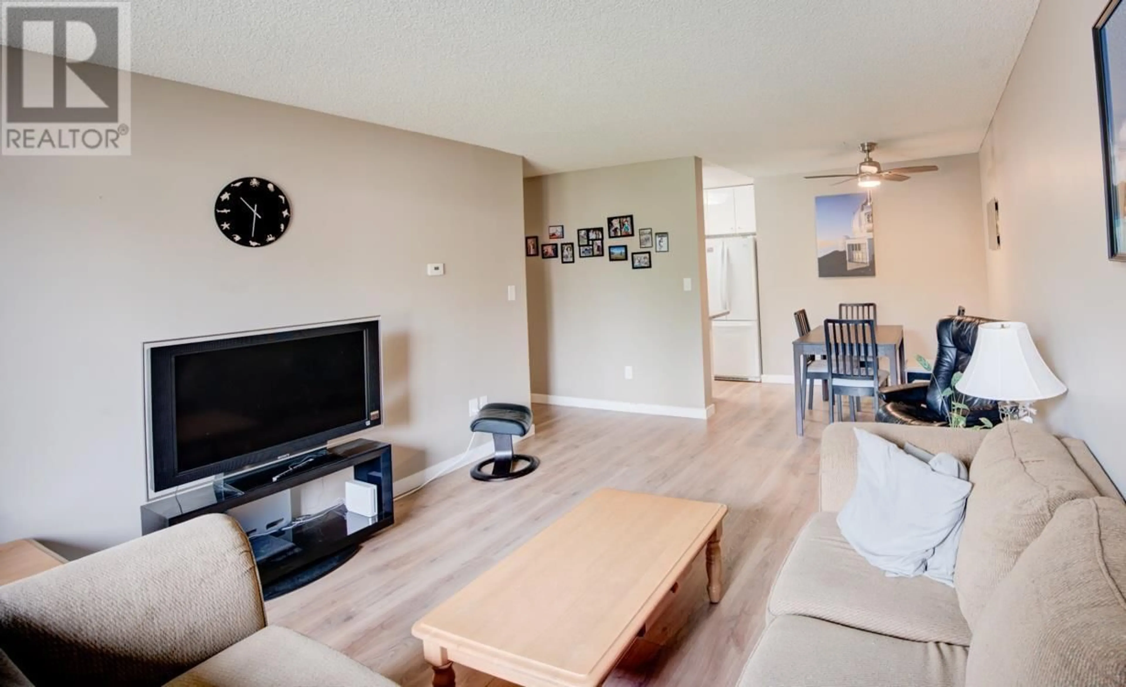 Living room with furniture, wood/laminate floor for 201 - 3921 CARRIGAN COURT, Burnaby British Columbia V3N4J7