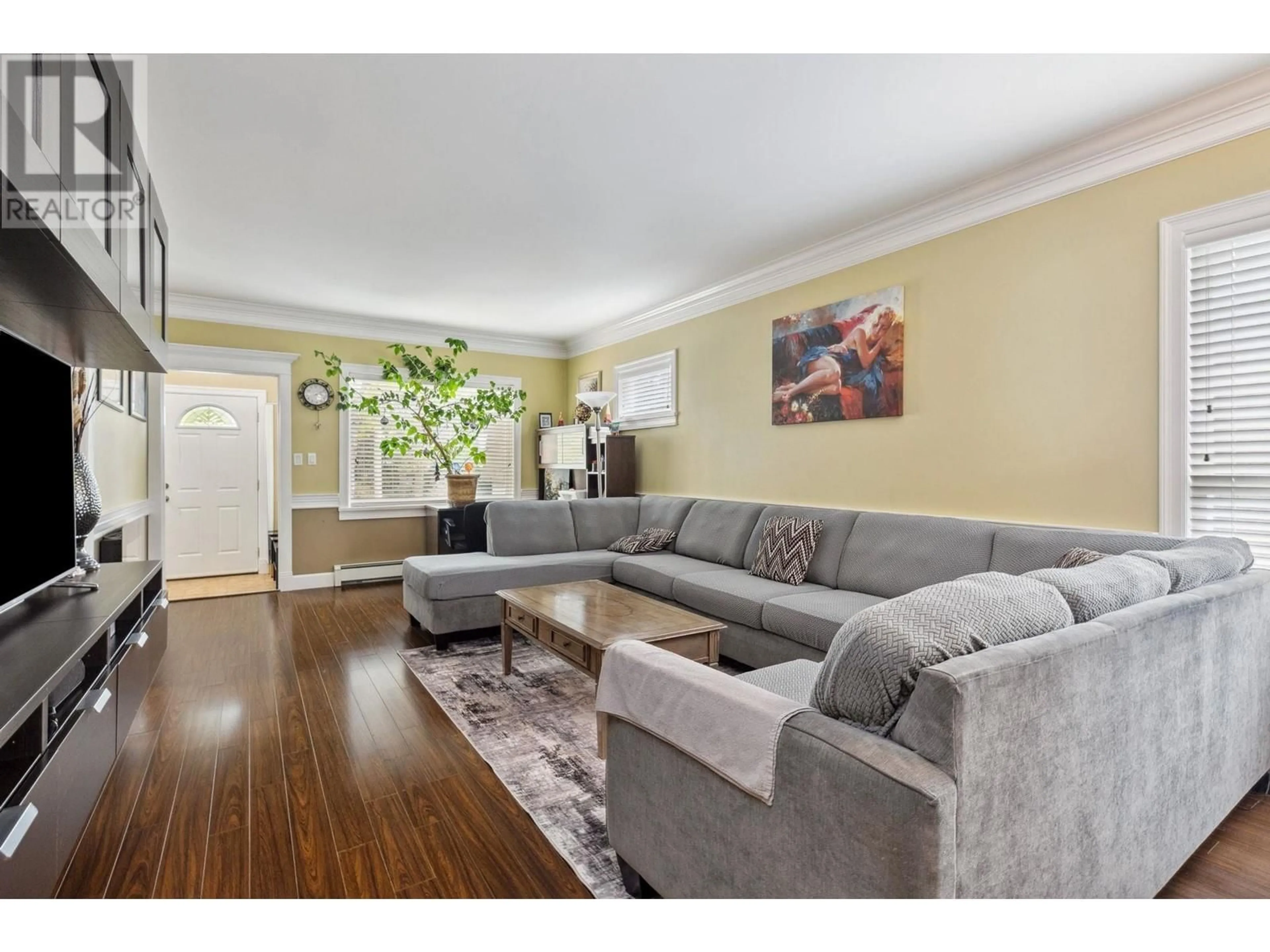 Living room with furniture, wood/laminate floor for 7445 19TH AVENUE, Burnaby British Columbia V3N1E2
