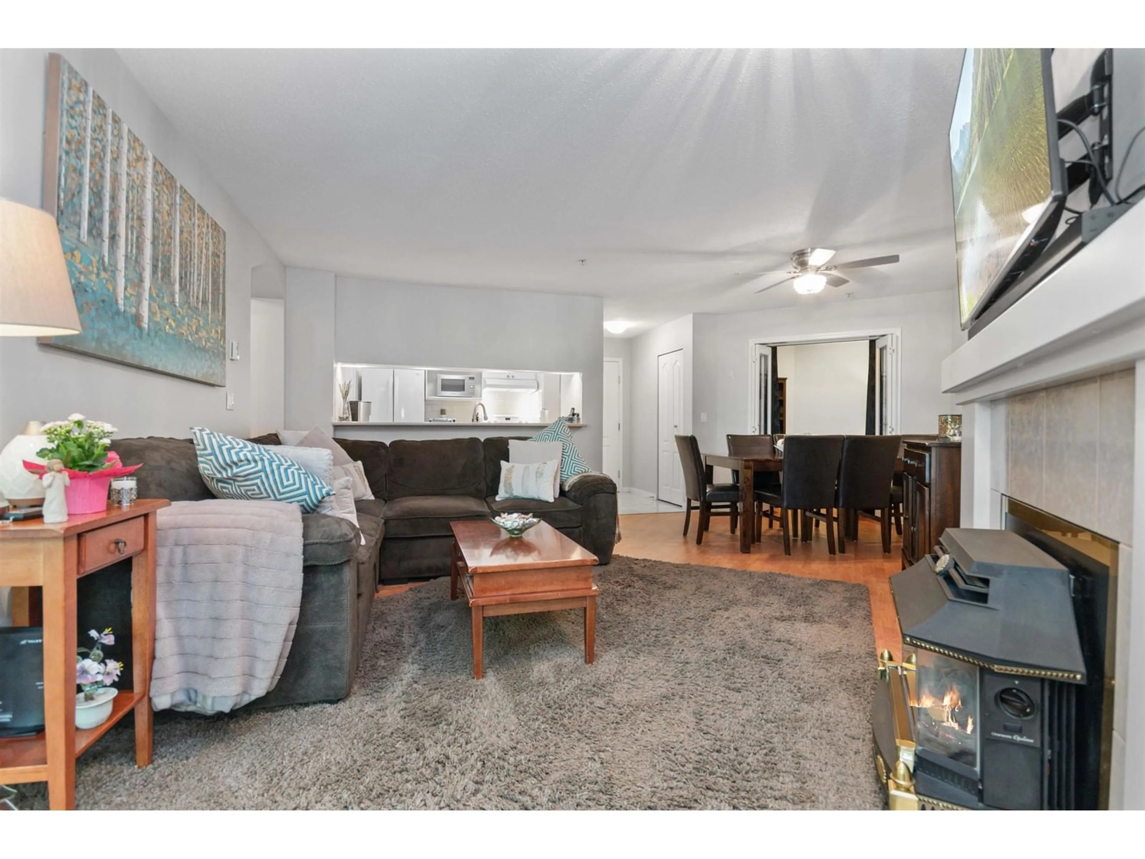 Living room with furniture, wood/laminate floor for 202 - 19528 FRASER, Surrey British Columbia V3S8P4