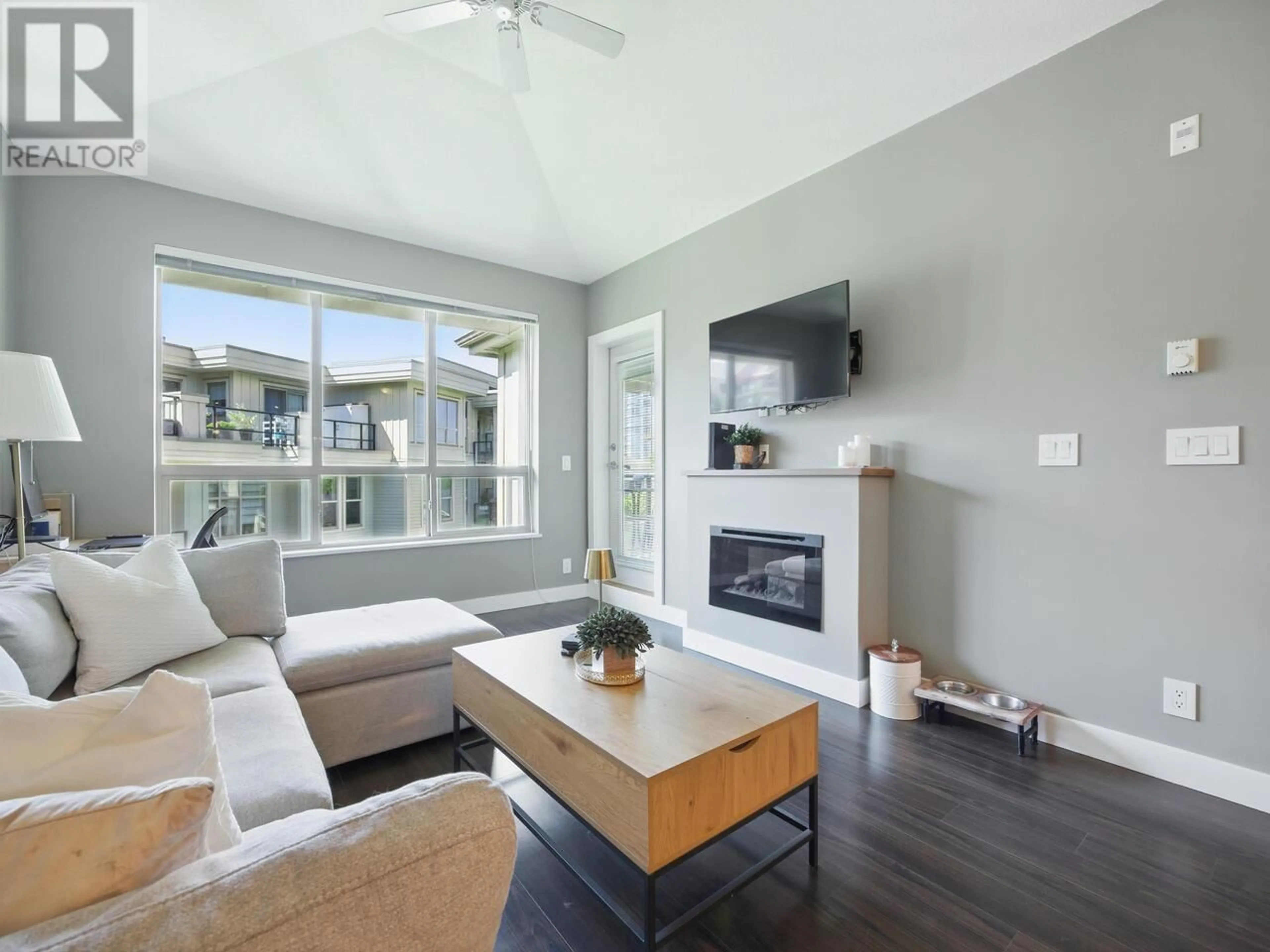 Living room with furniture, wood/laminate floor for 407 - 240 FRANCIS WAY, New Westminster British Columbia V3L0E5