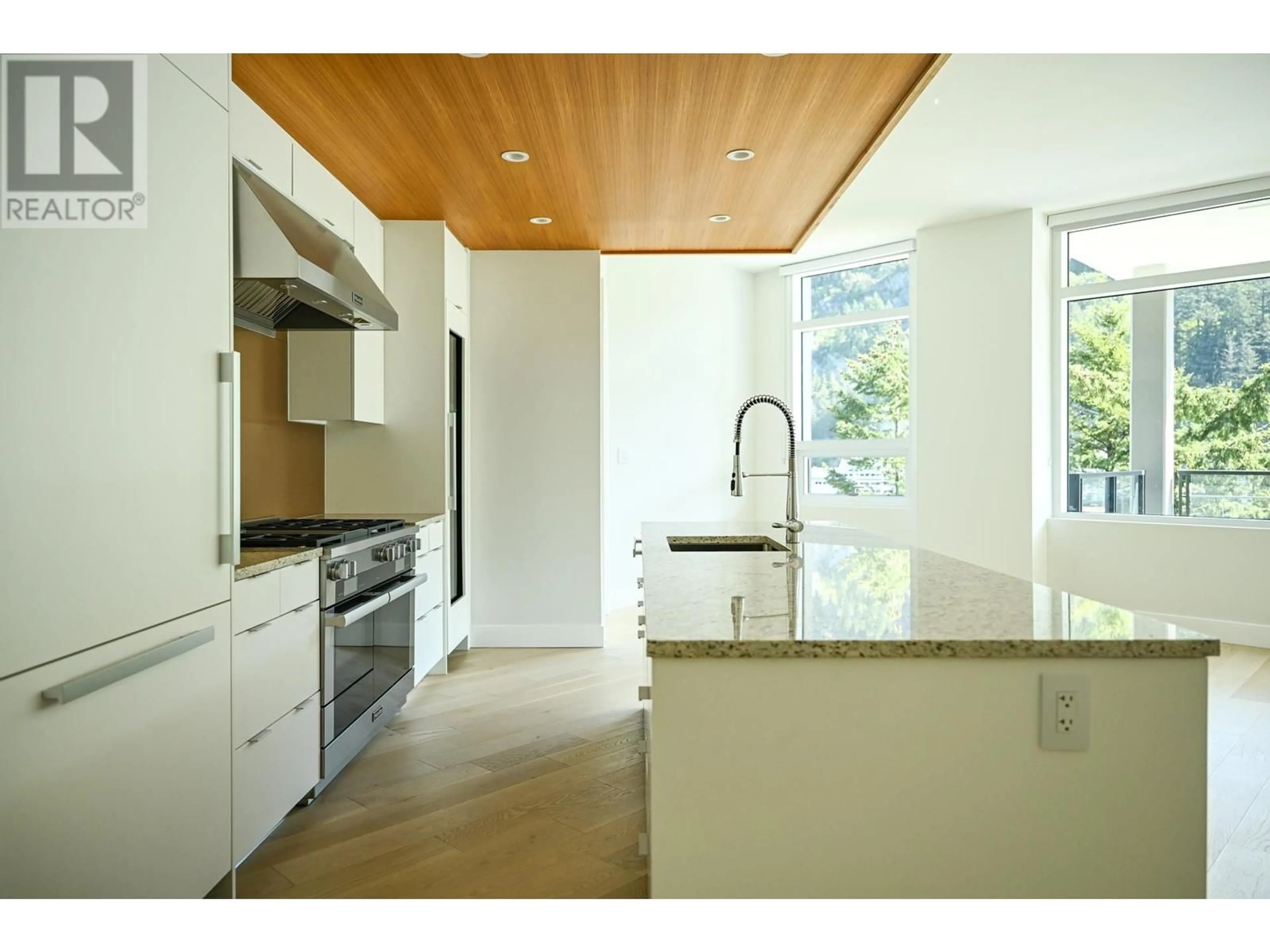 Contemporary kitchen, wood/laminate floor for 302 - 6707 NELSON AVENUE, West Vancouver British Columbia V7W0A4