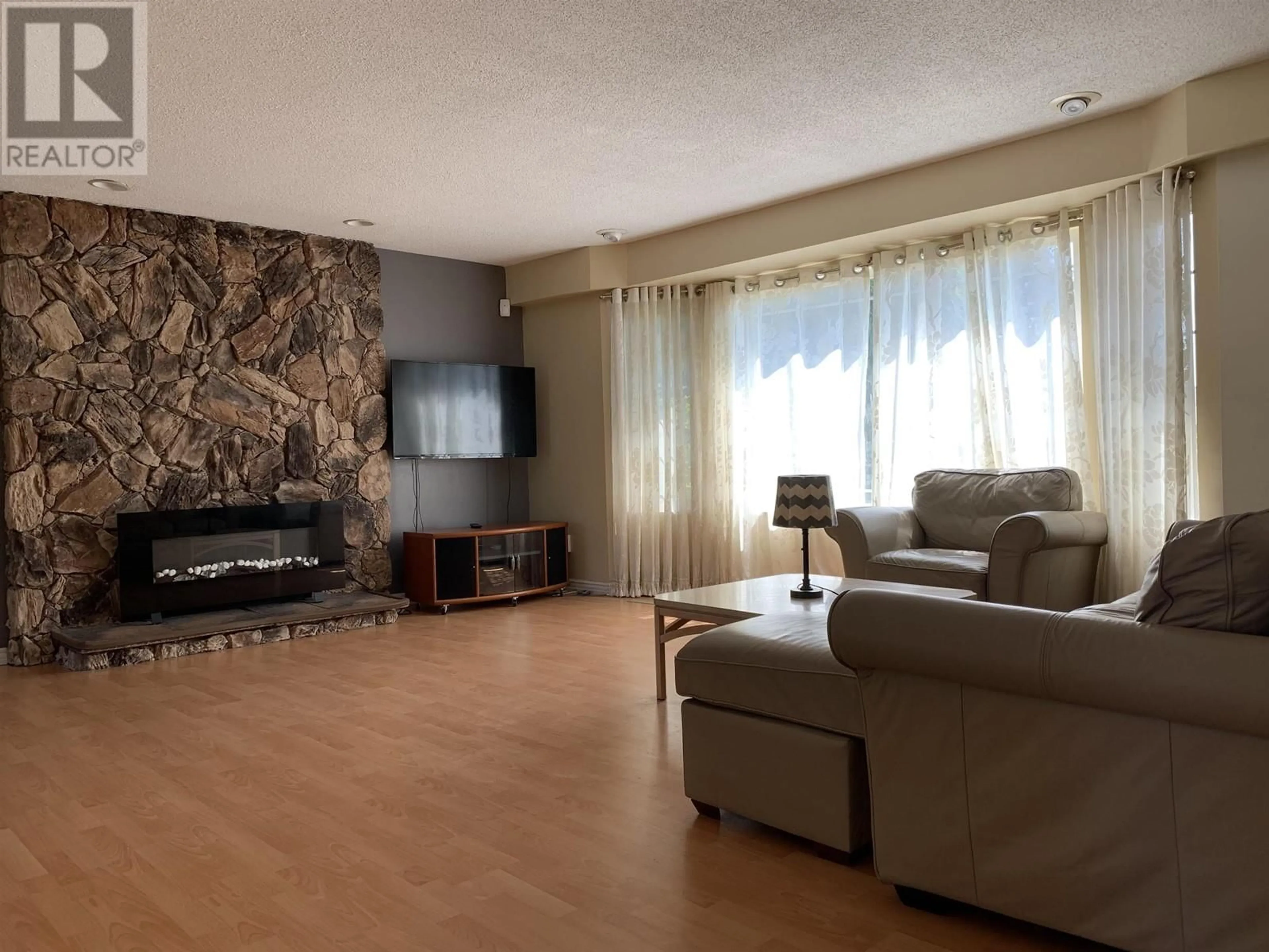 Living room with furniture, wood/laminate floor for 10260 BAMBERTON DRIVE, Richmond British Columbia V7A1K3