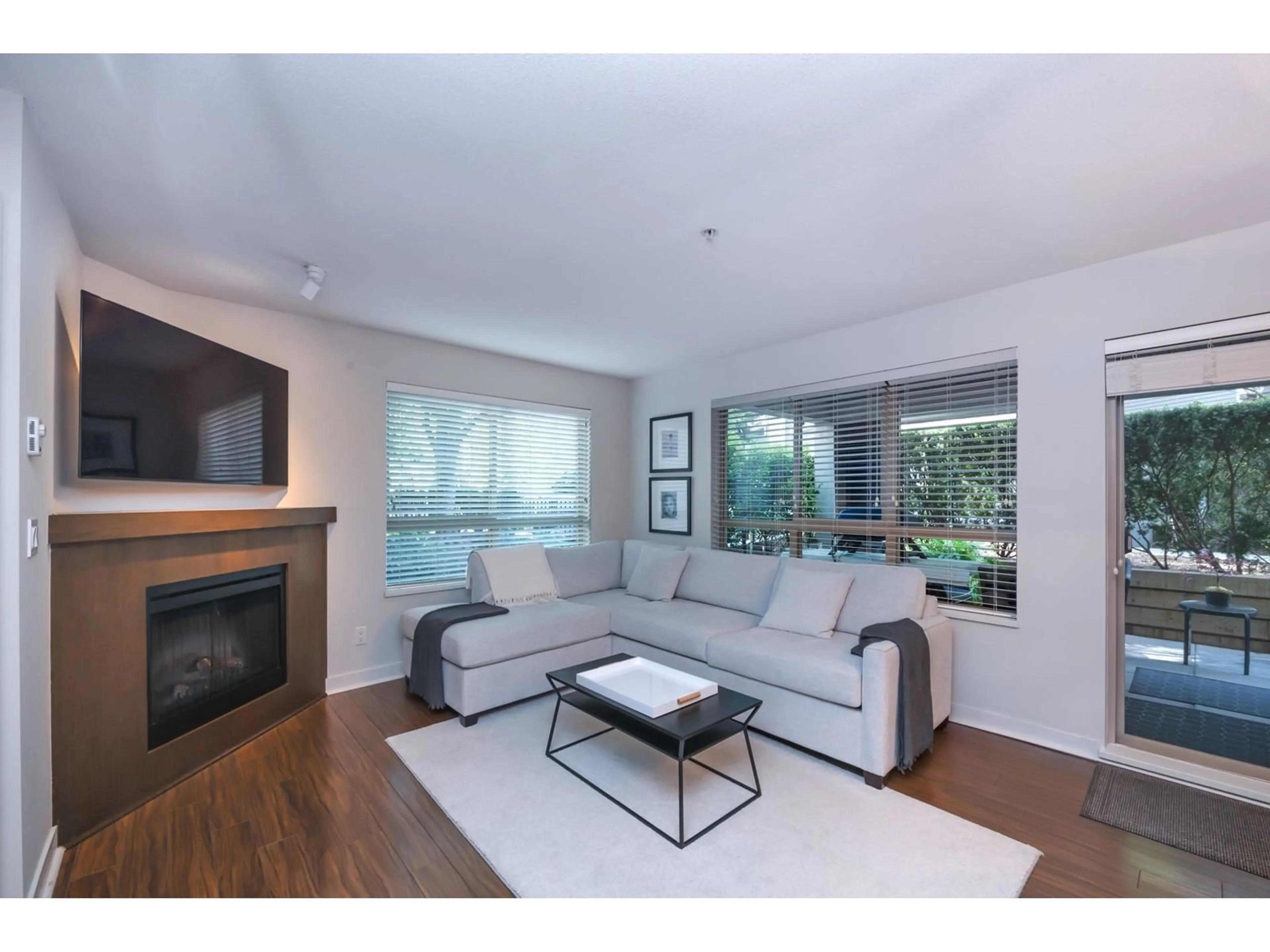 Living room with furniture, wood/laminate floor for C104 - 8929 202, Langley British Columbia V1M0B4