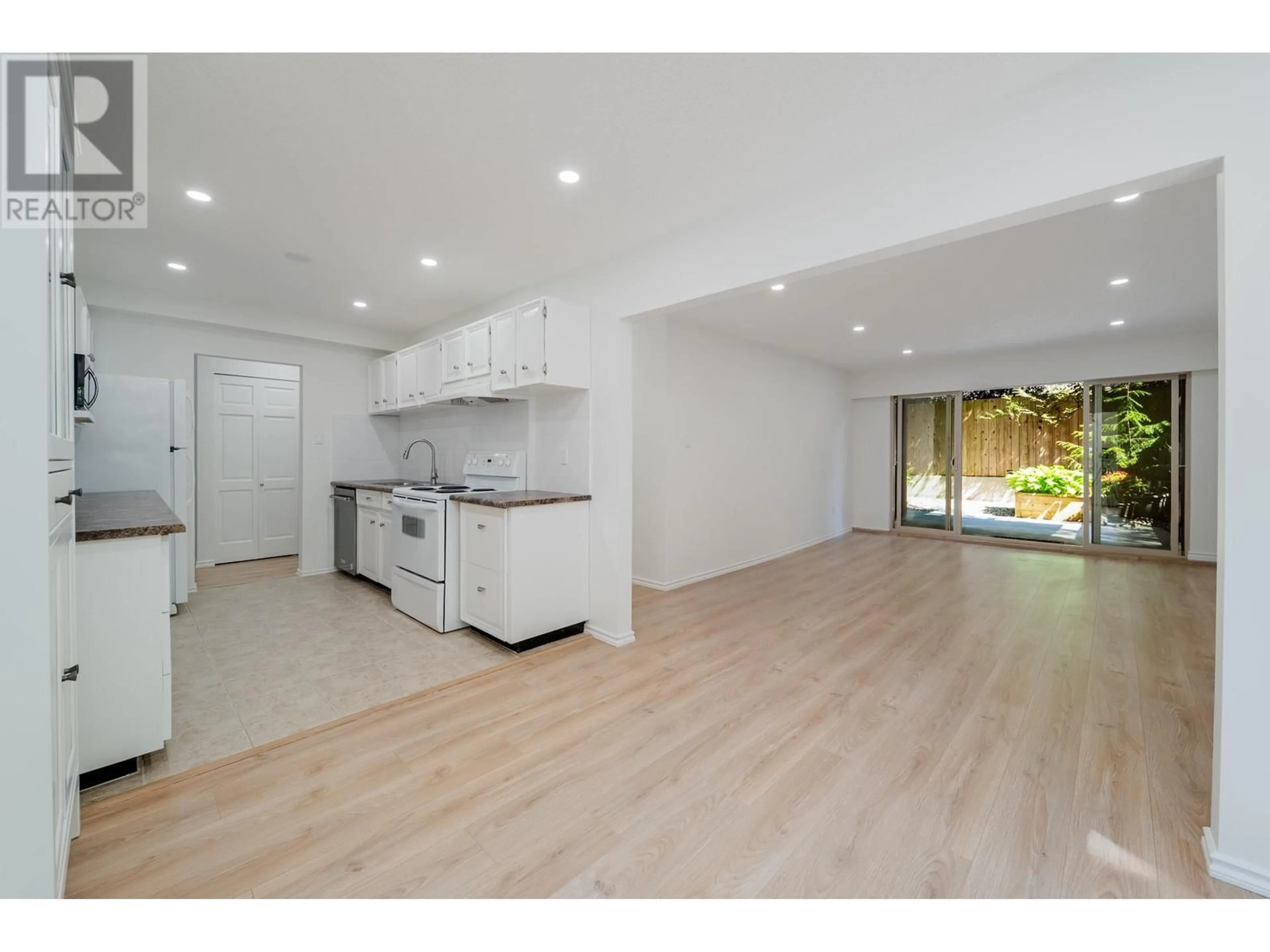 Open concept kitchen, wood/laminate floor for 102 - 150 5TH STREET, North Vancouver British Columbia V7L1L5