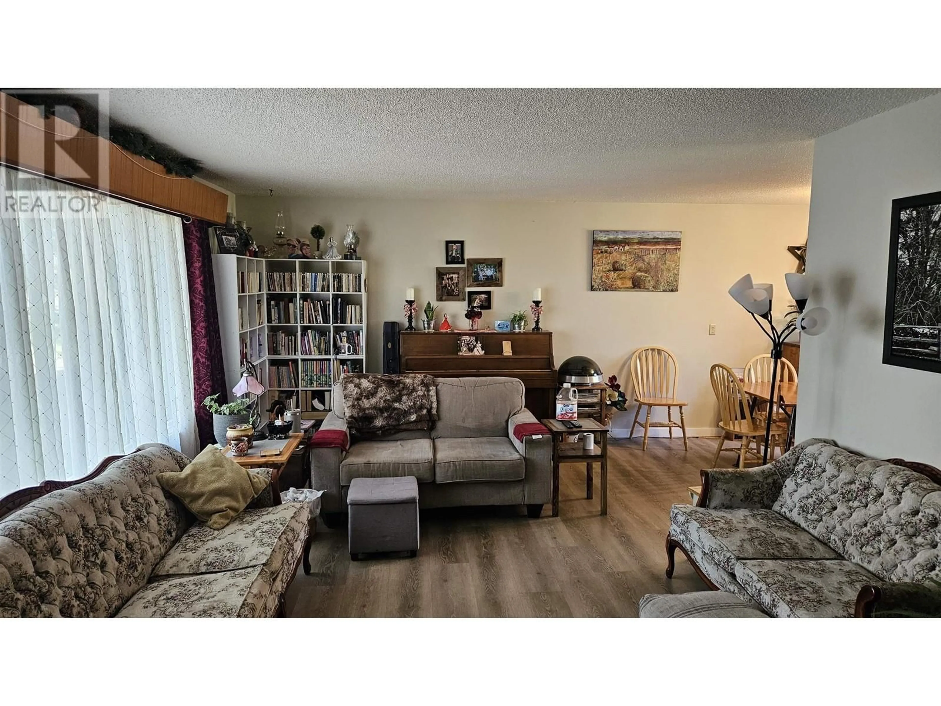Living room with furniture, wood/laminate floor for 6151 ROWANTREE AVENUE, Fort St. John British Columbia V0C1C0
