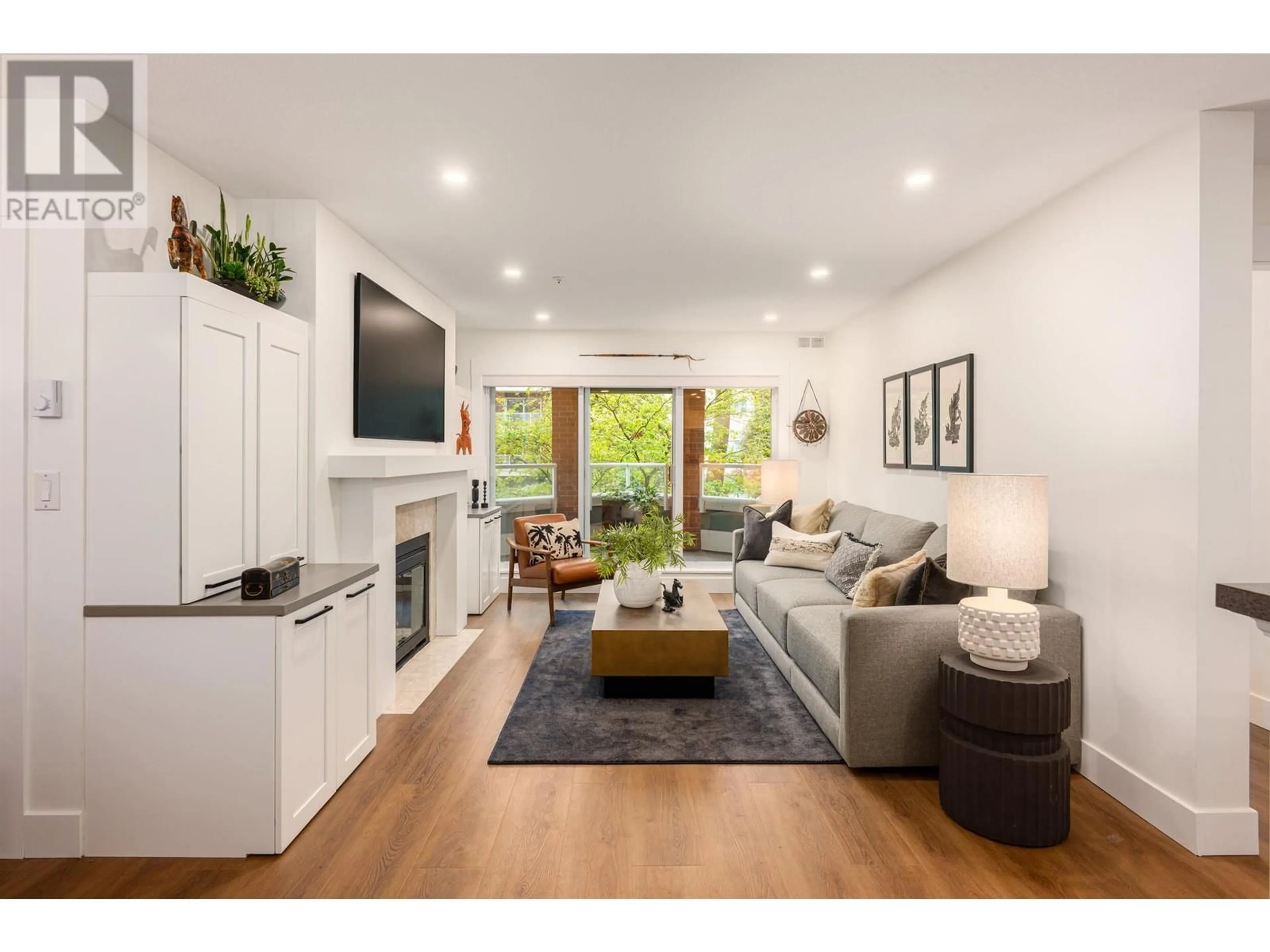 Living room with furniture, wood/laminate floor for 208 - 128 8TH STREET, North Vancouver British Columbia V7M3M1