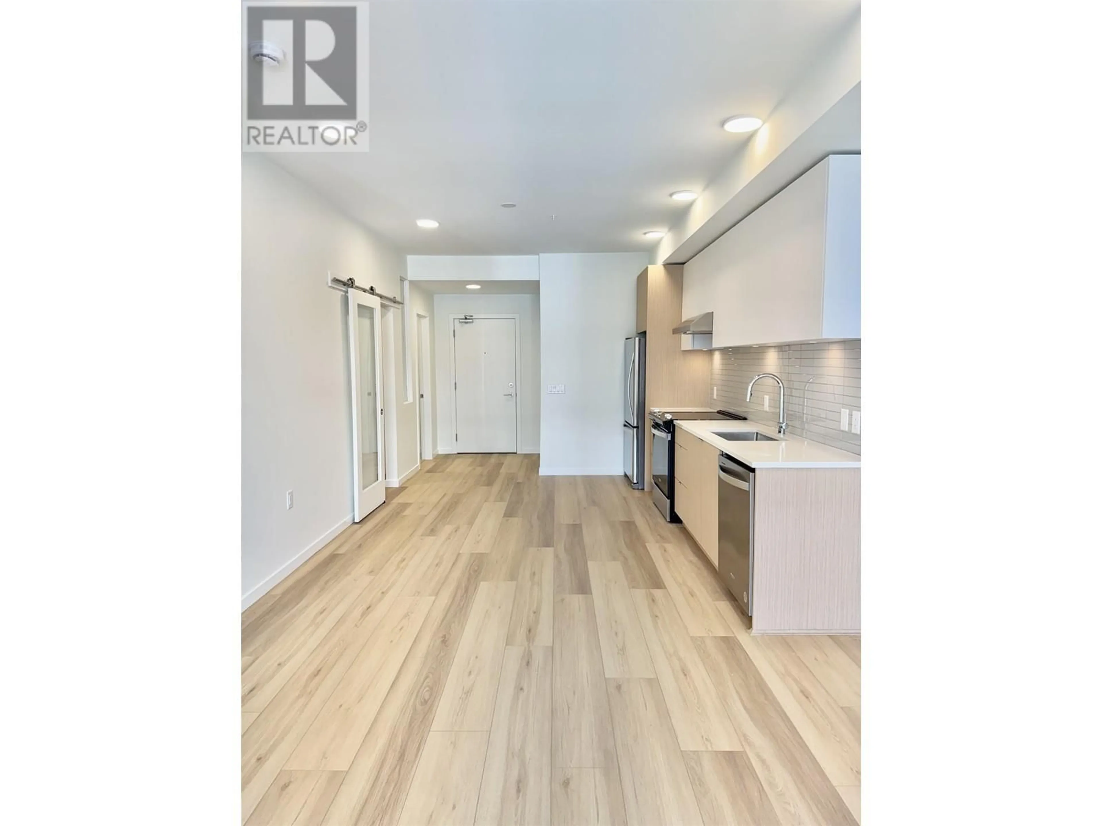 Open concept kitchen, wood/laminate floor for 305 - 37994 SECOND AVENUE, Squamish British Columbia V8B0C3