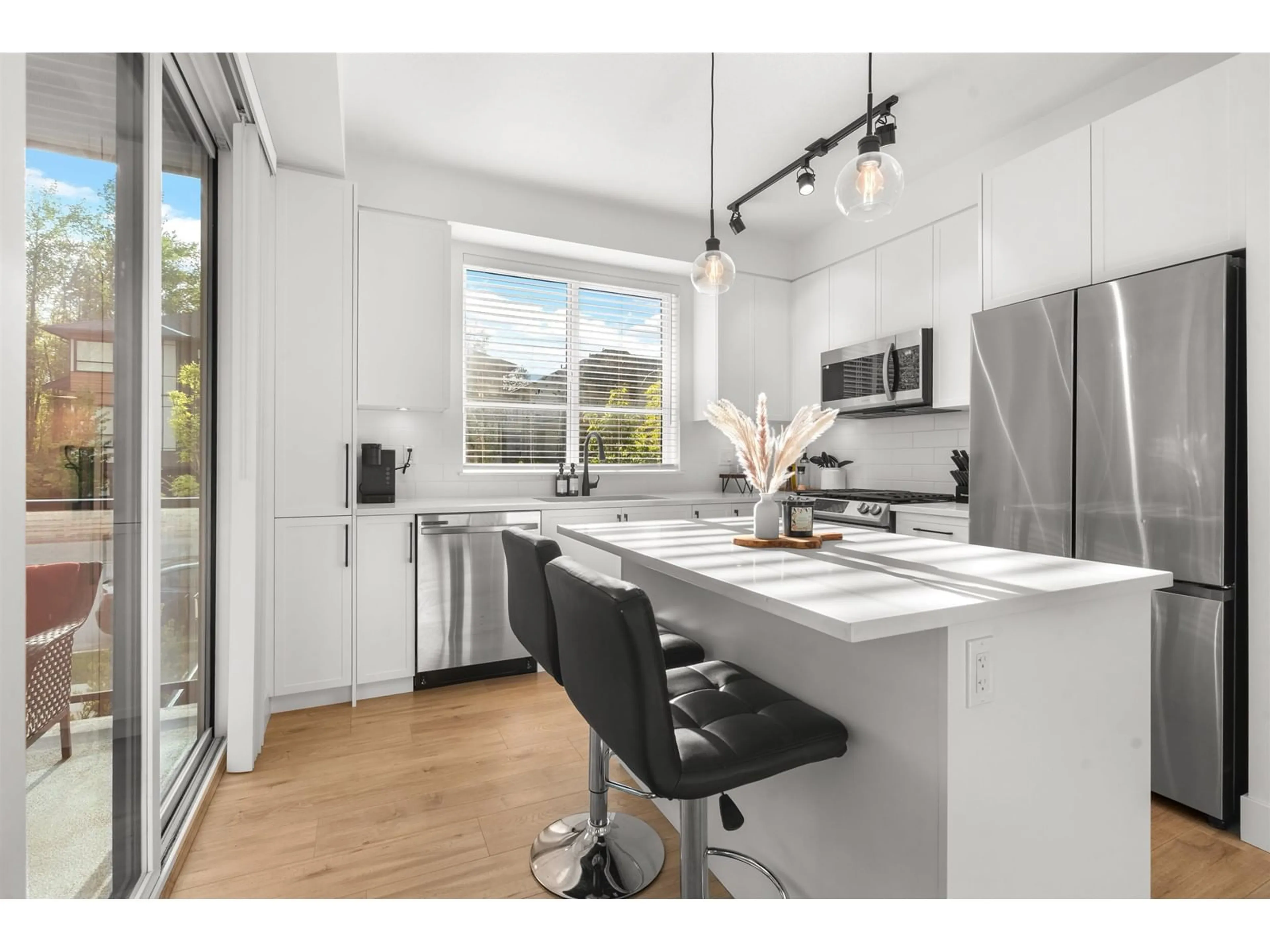 Open concept kitchen, wood/laminate floor for 207 - 7506 199A, Langley British Columbia V2Y3K9