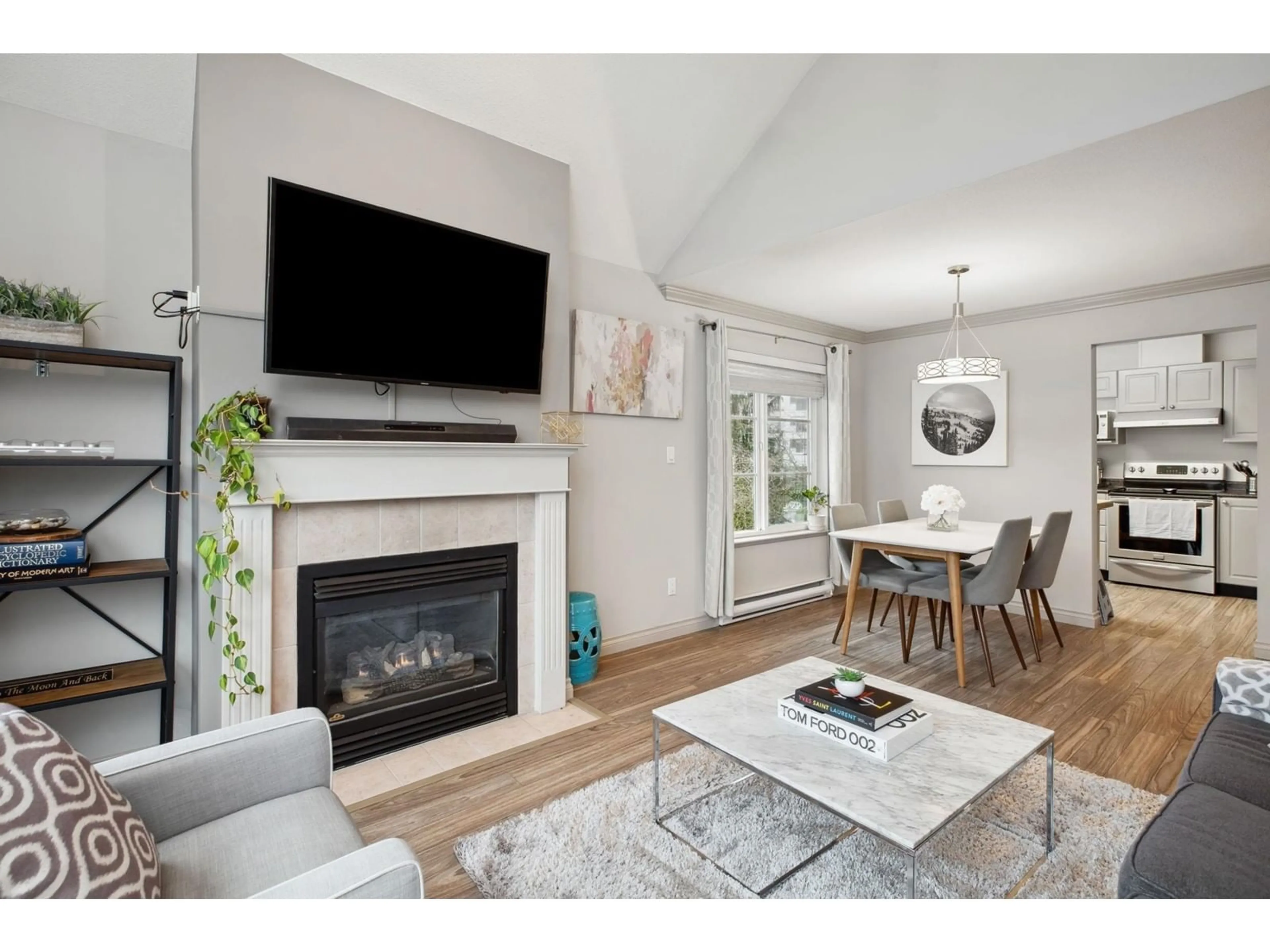 Living room with furniture, wood/laminate floor for 310 - 10130 139, Surrey British Columbia V3T4L4