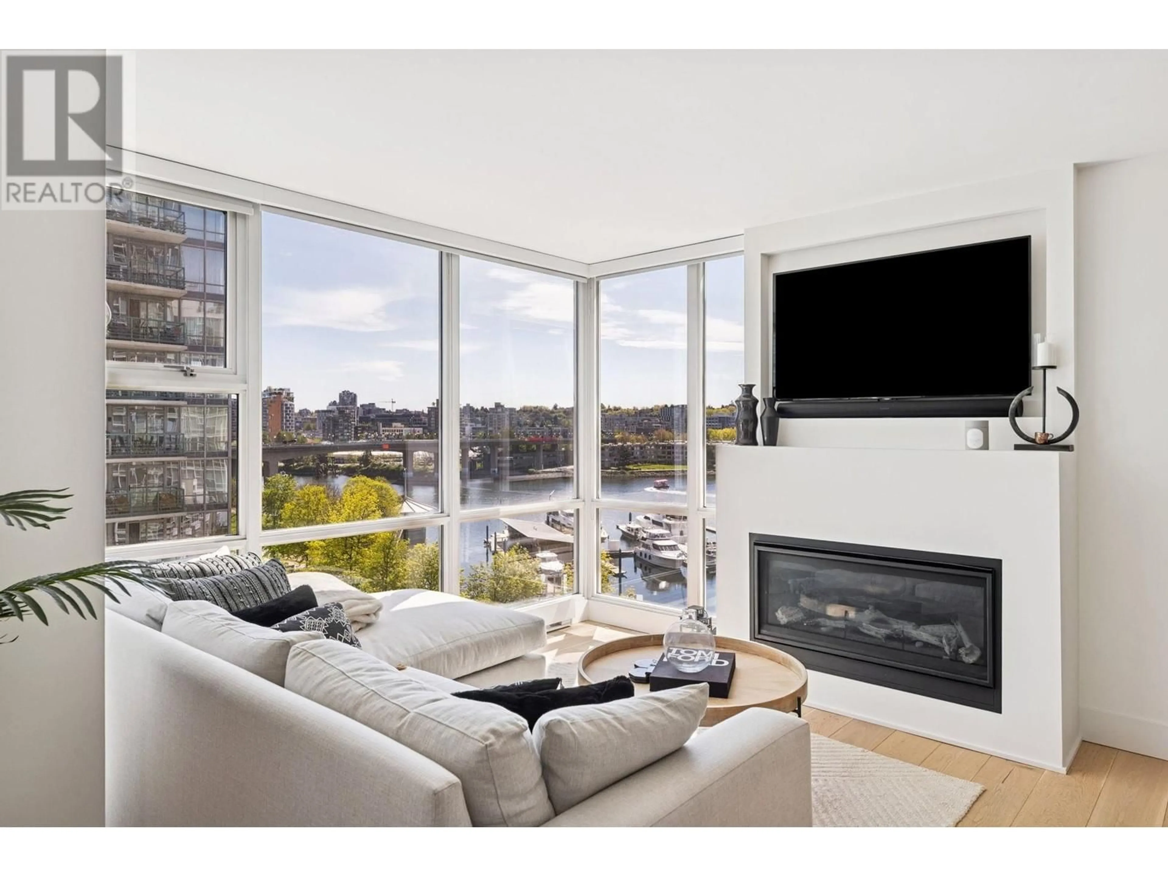 Living room with furniture, wood/laminate floor for 801 - 1077 MARINASIDE CRESCENT, Vancouver British Columbia V6Z2Z5