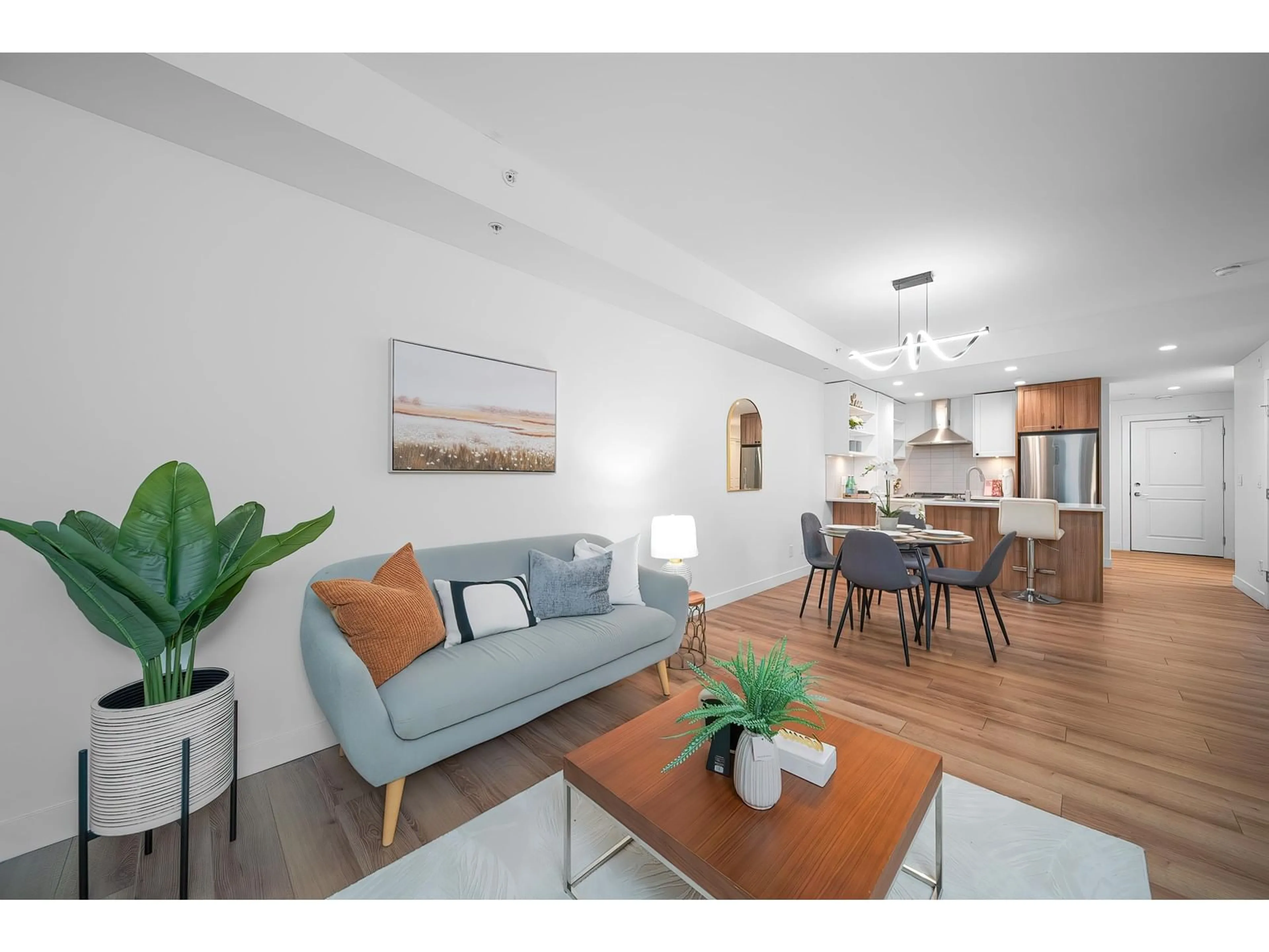 Living room with furniture, wood/laminate floor for B411 - 20487 65, Langley British Columbia V2Y3K5