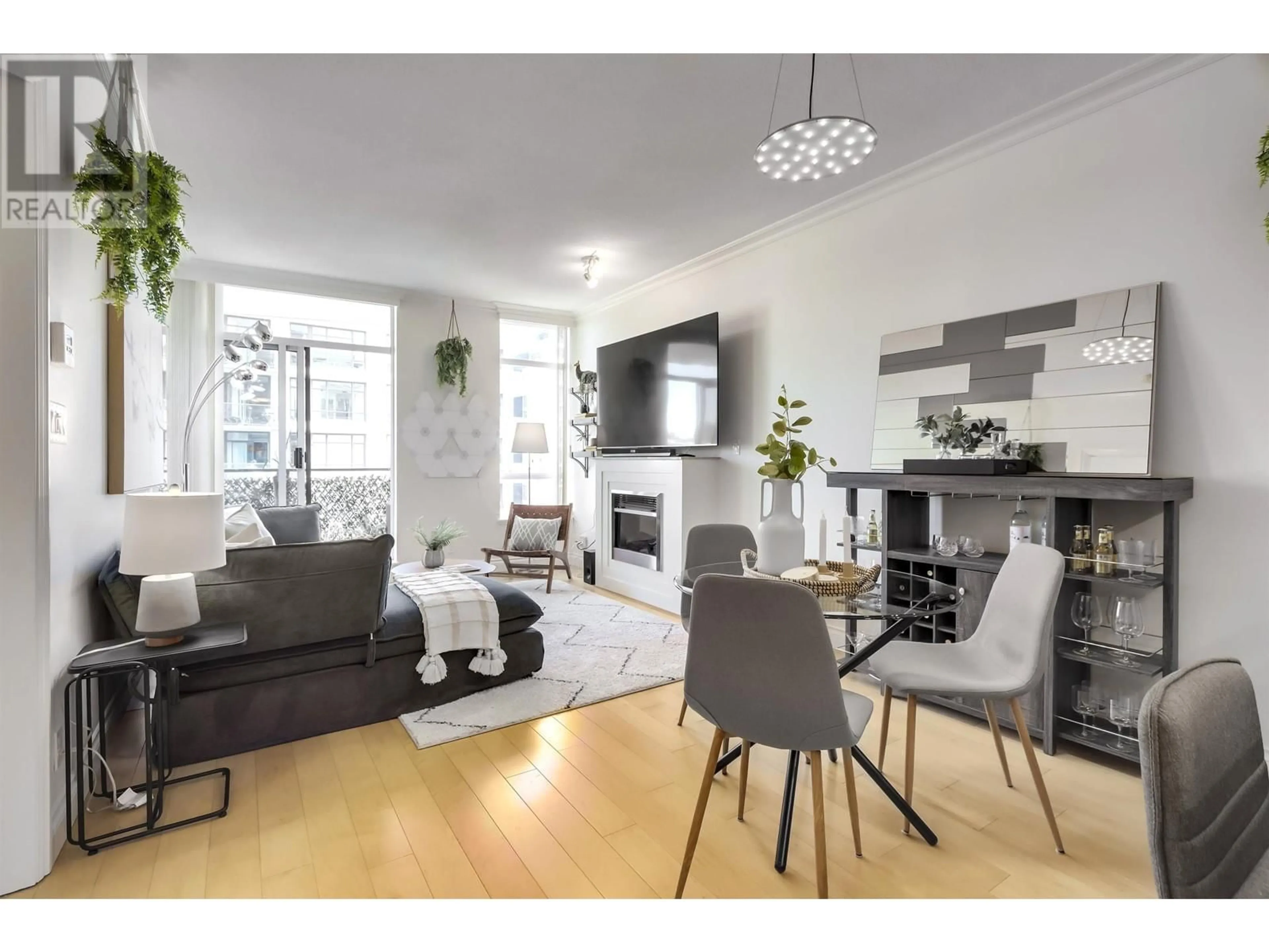 Living room with furniture, wood/laminate floor for 903 - 162 VICTORY SHIP WAY, North Vancouver British Columbia V7L0B4