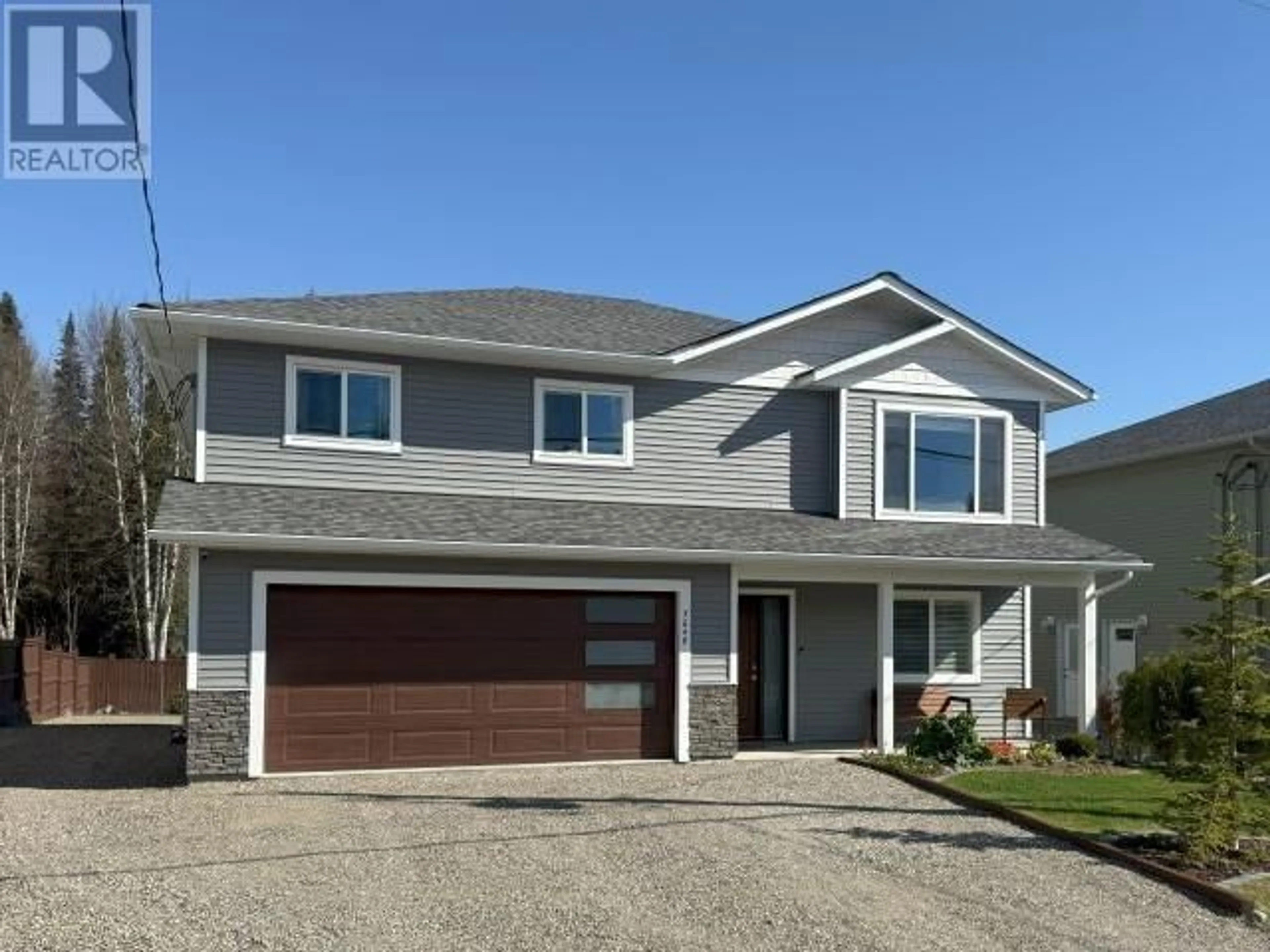 Home with vinyl exterior material, street for 7048 HILLU ROAD, Prince George British Columbia V2K0B4