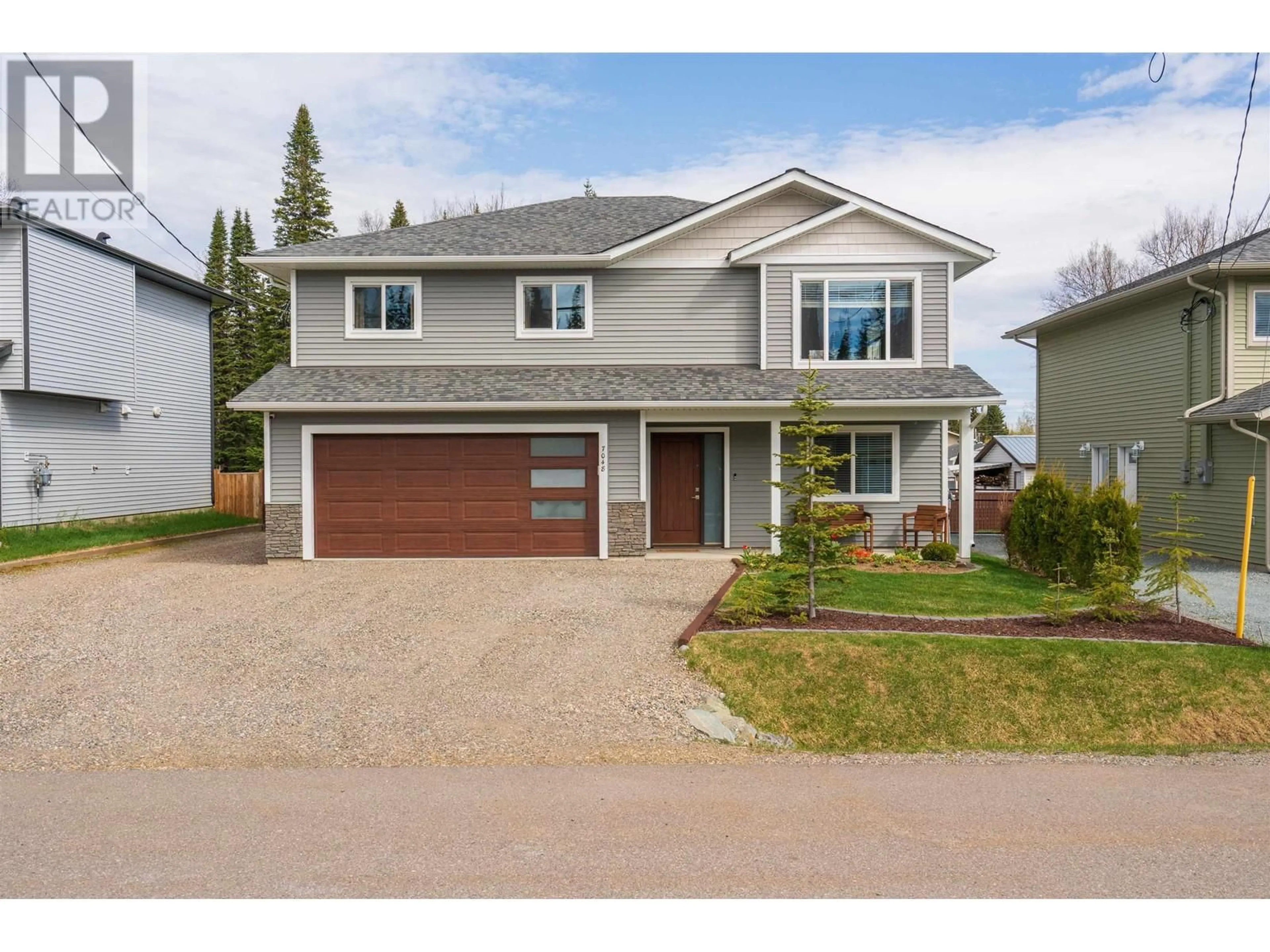 Home with vinyl exterior material, street for 7048 HILLU ROAD, Prince George British Columbia V2K0B4