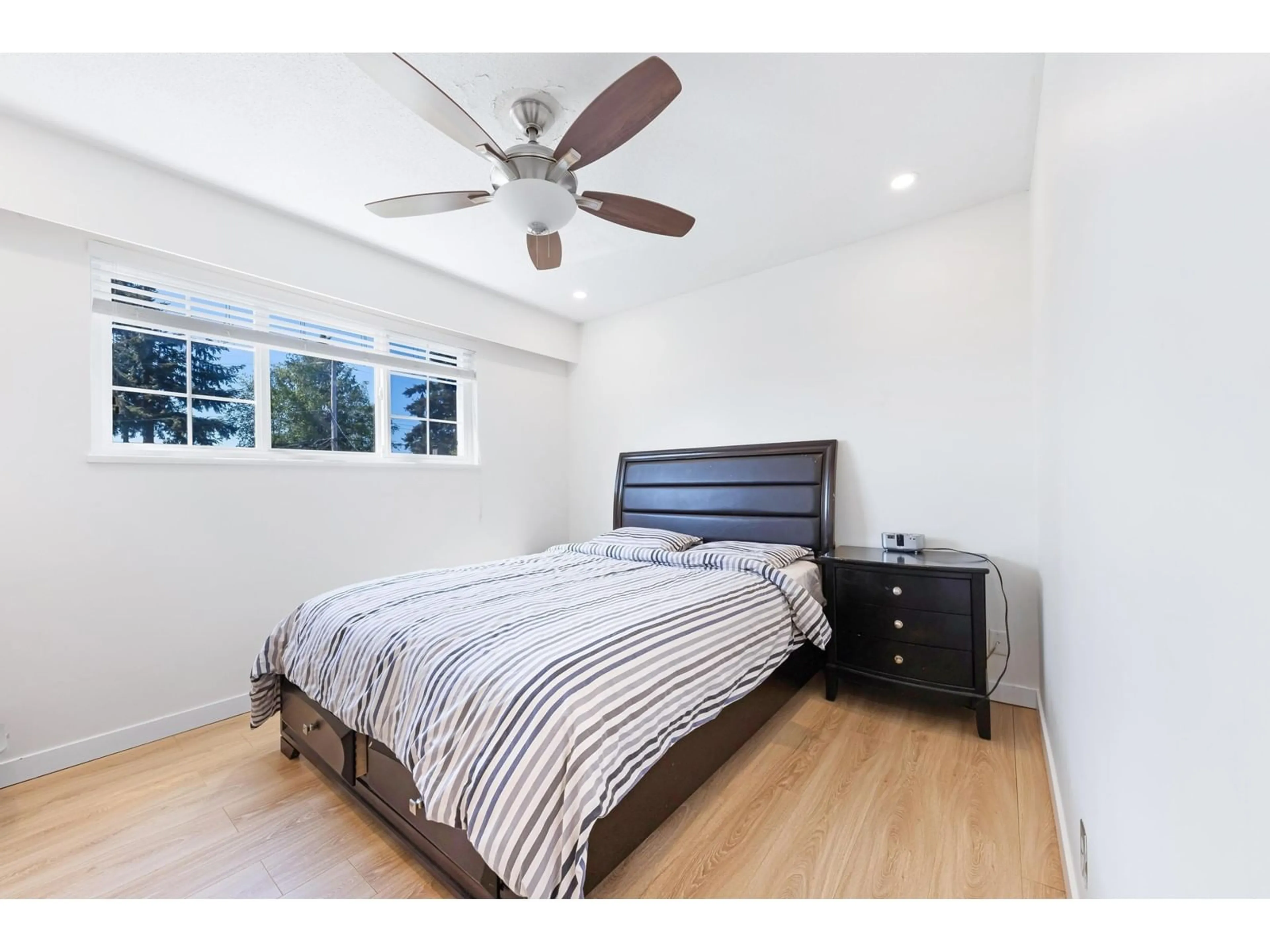 Bedroom with bed, wood/laminate floor for 7444 MINSTER WEST, Delta British Columbia V4C4L7