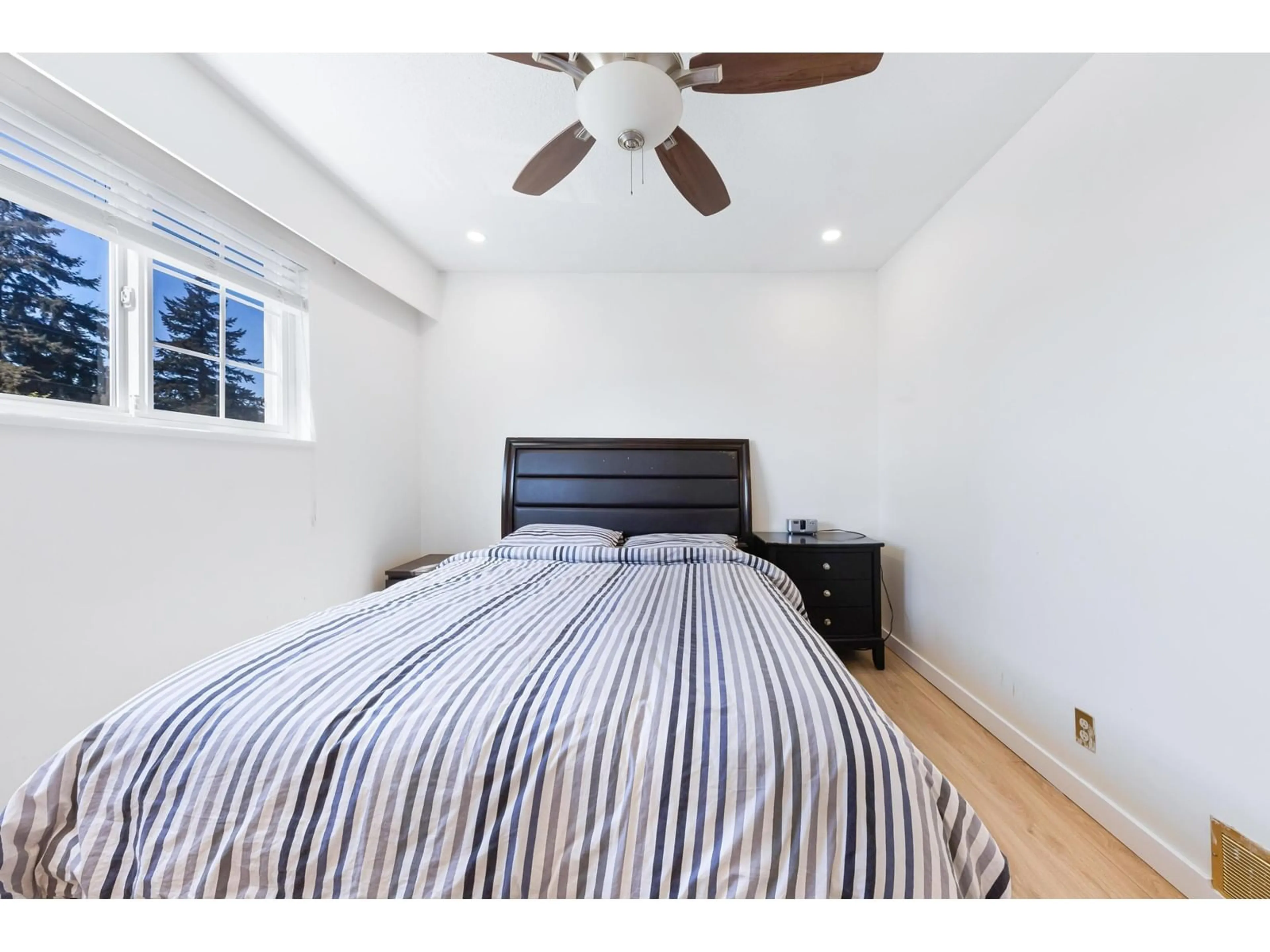 Bedroom with bed, wood/laminate floor for 7444 MINSTER WEST, Delta British Columbia V4C4L7