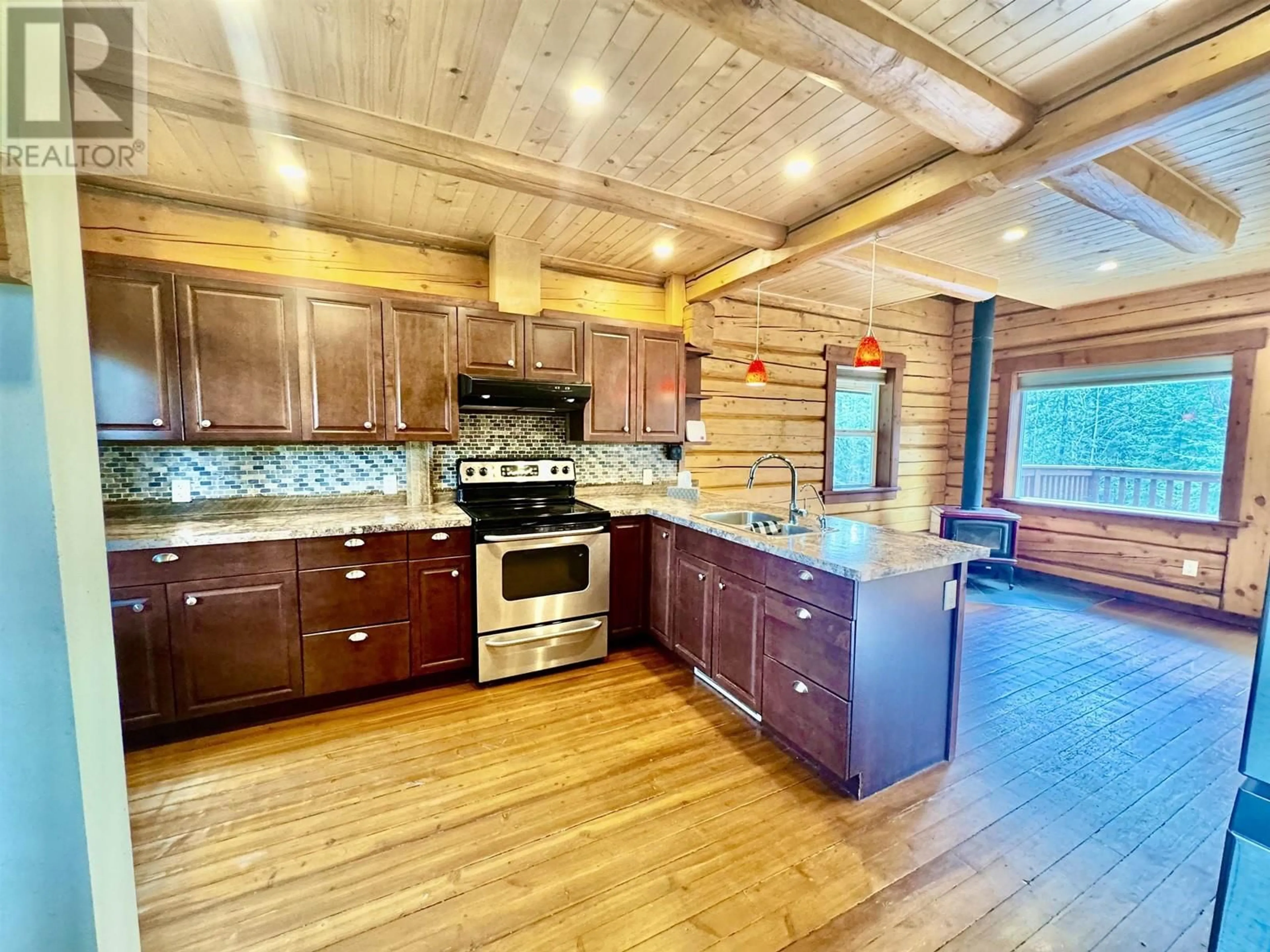 Open concept kitchen, wood/laminate floor for 4086 LAC LA HACHE STATION ROAD, Lac La Hache British Columbia V0K1T1
