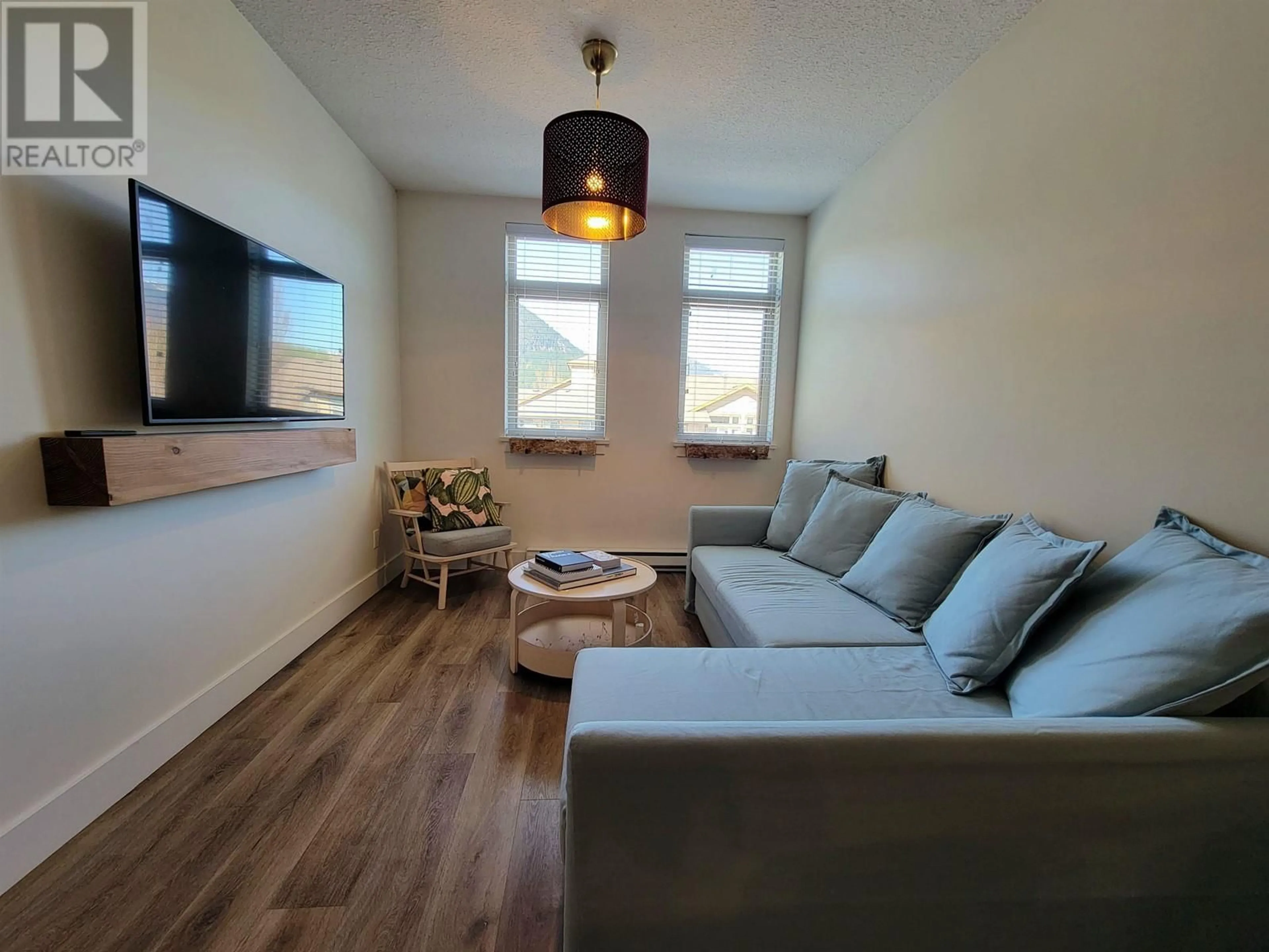 Living room with furniture, wood/laminate floor for 305 - 7330 ARBUTUS STREET, Pemberton British Columbia V0N2L1