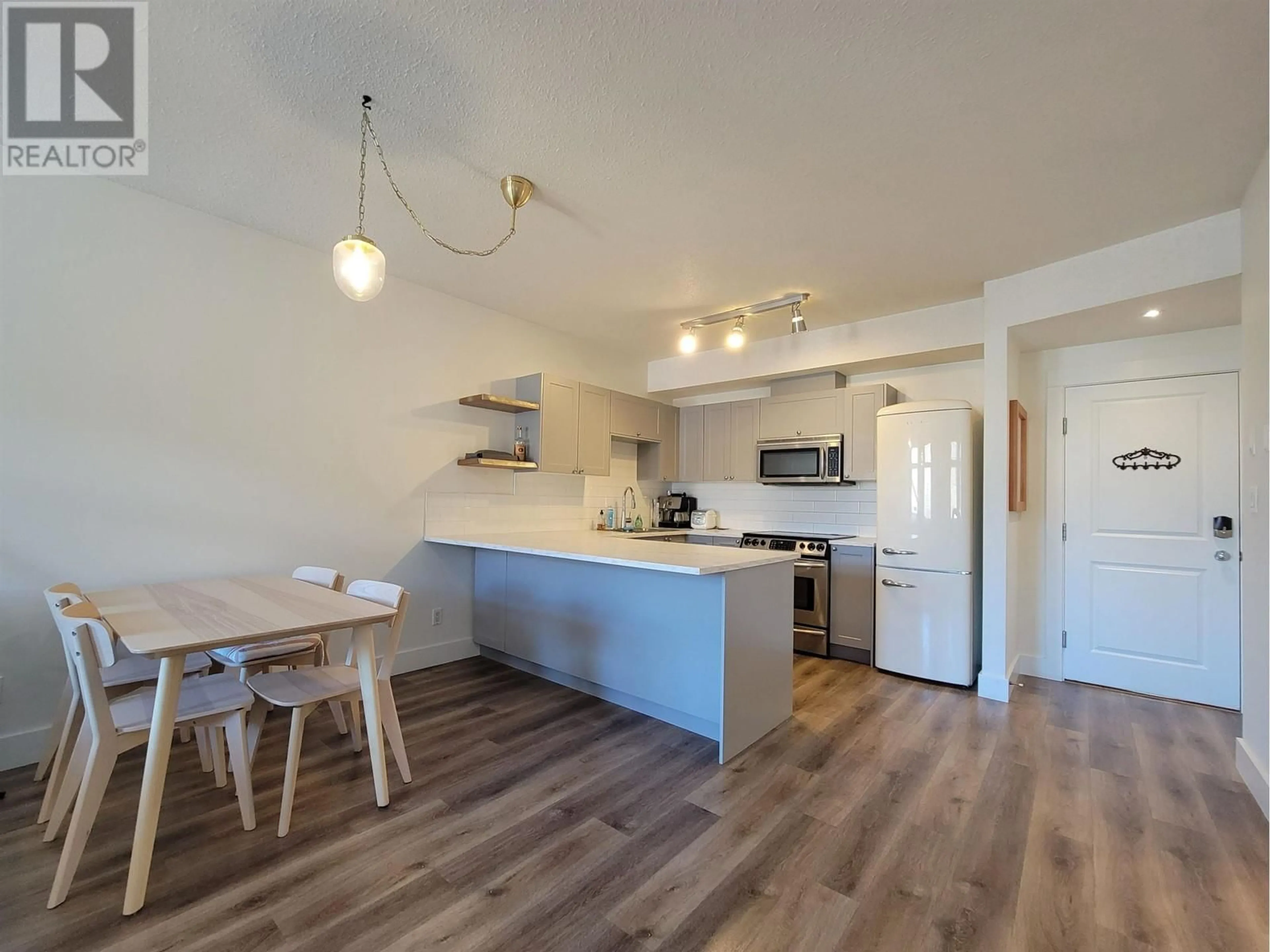 Open concept kitchen, wood/laminate floor for 305 - 7330 ARBUTUS STREET, Pemberton British Columbia V0N2L1