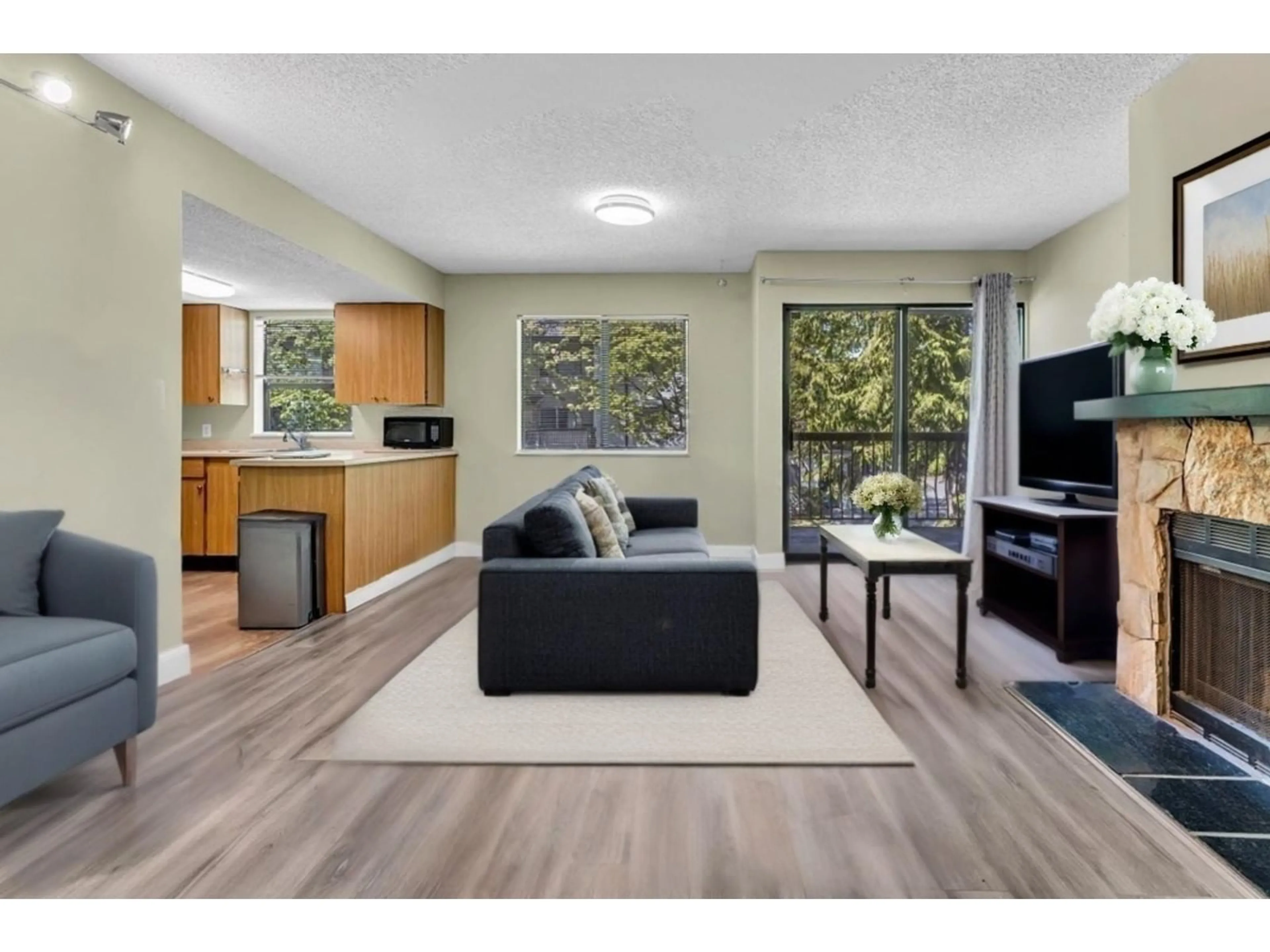 Living room with furniture, wood/laminate floor for 201 - 13316 71B, Surrey British Columbia V3W7Z4
