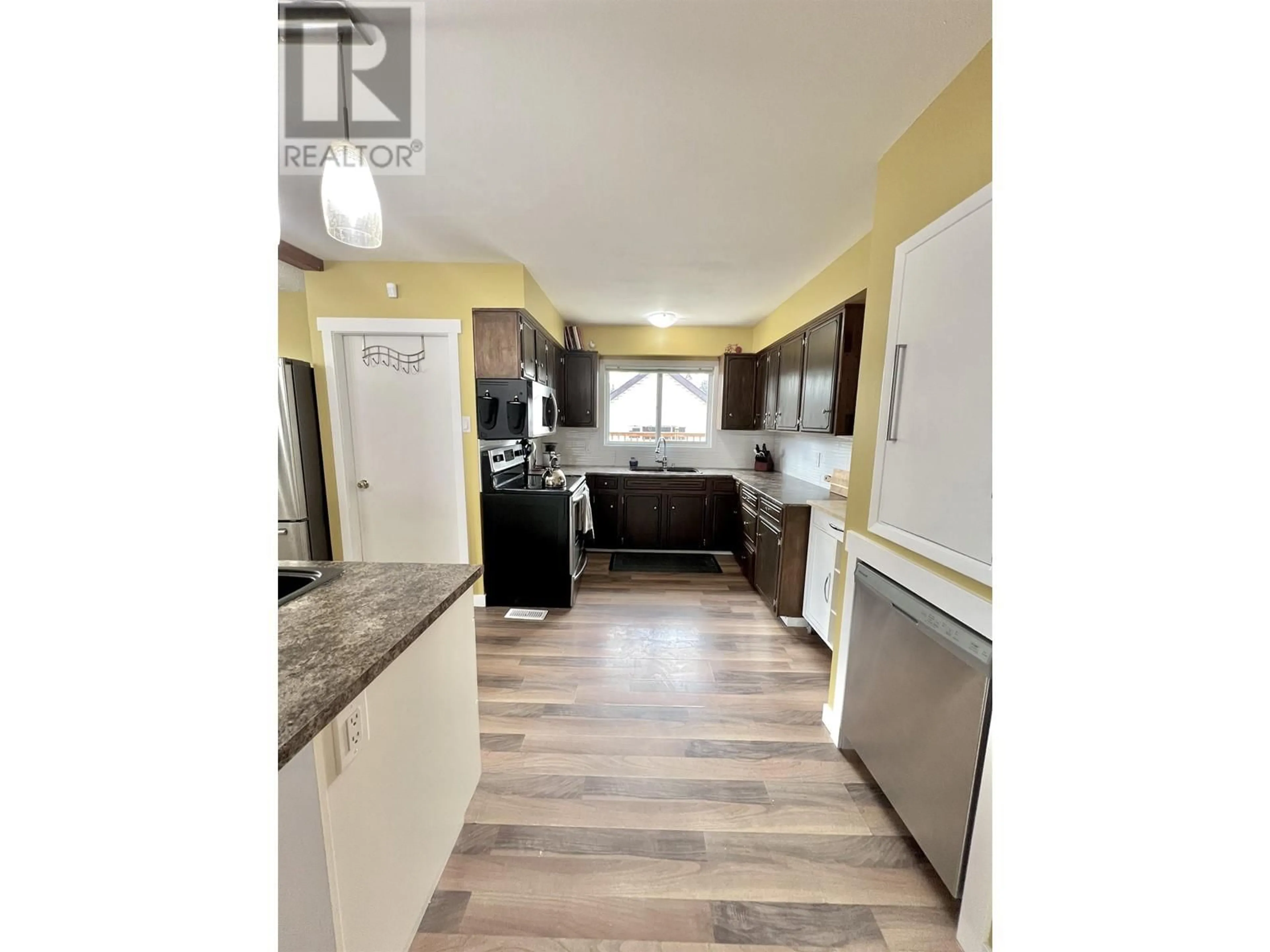 Open concept kitchen, wood/laminate floor for 1467 FRASER CRESCENT, Prince George British Columbia V2M3Y4