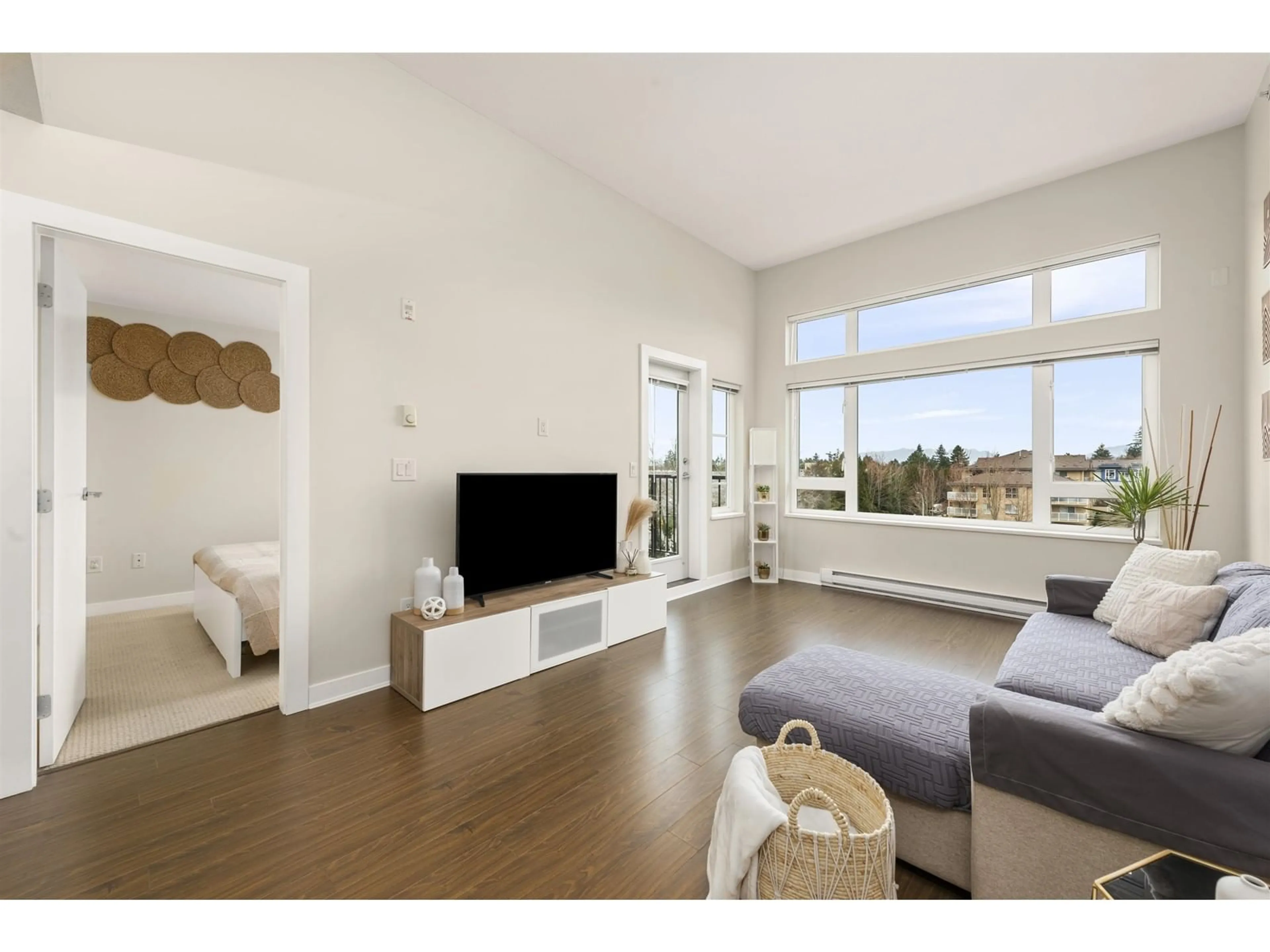 Living room with furniture, wood/laminate floor for 408 - 13740 75A, Surrey British Columbia V3W0E8