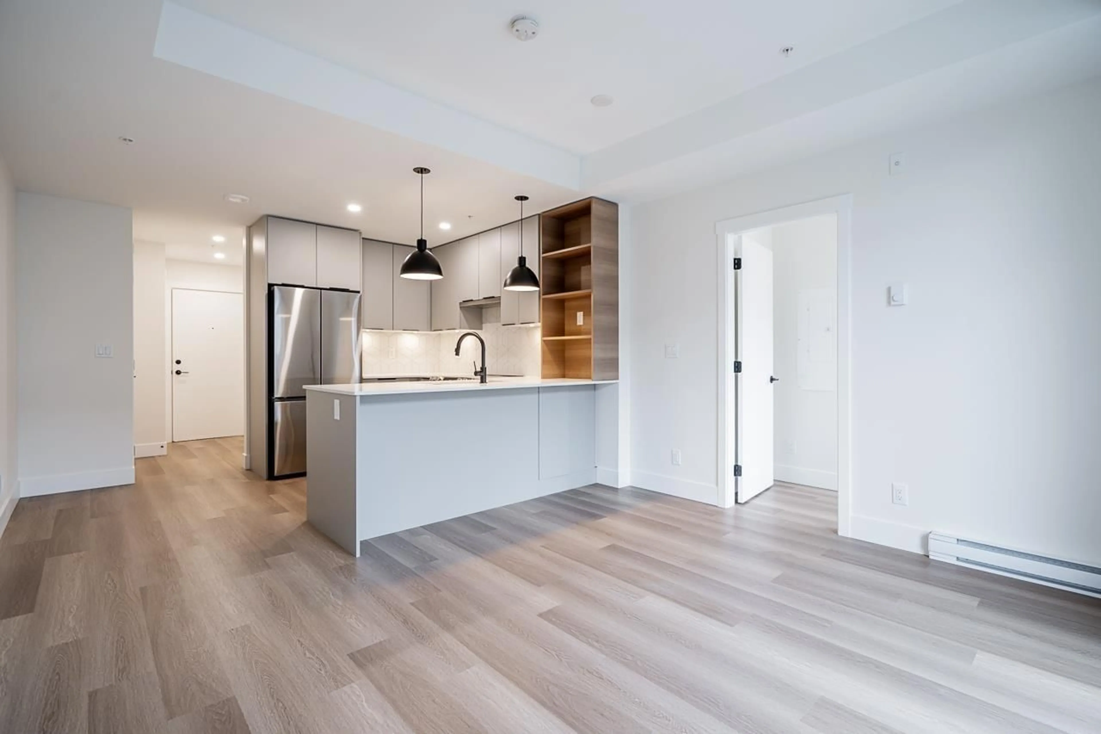 Open concept kitchen, wood/laminate floor for 405 - 10778 138, Surrey British Columbia V3T5T2