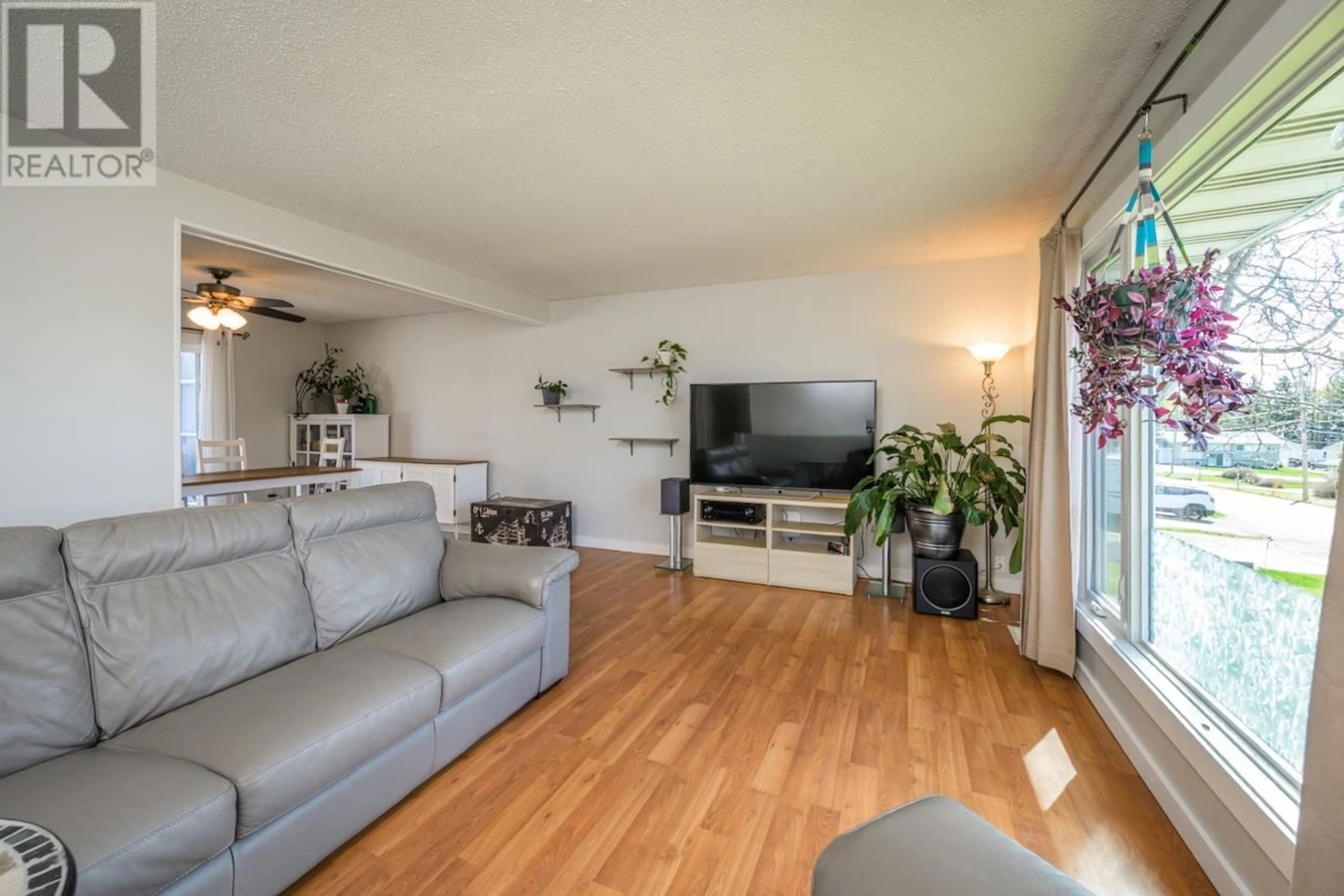 Living room with furniture, wood/laminate floor for 7410 THOMPSON DRIVE, Prince George British Columbia V2N5N5