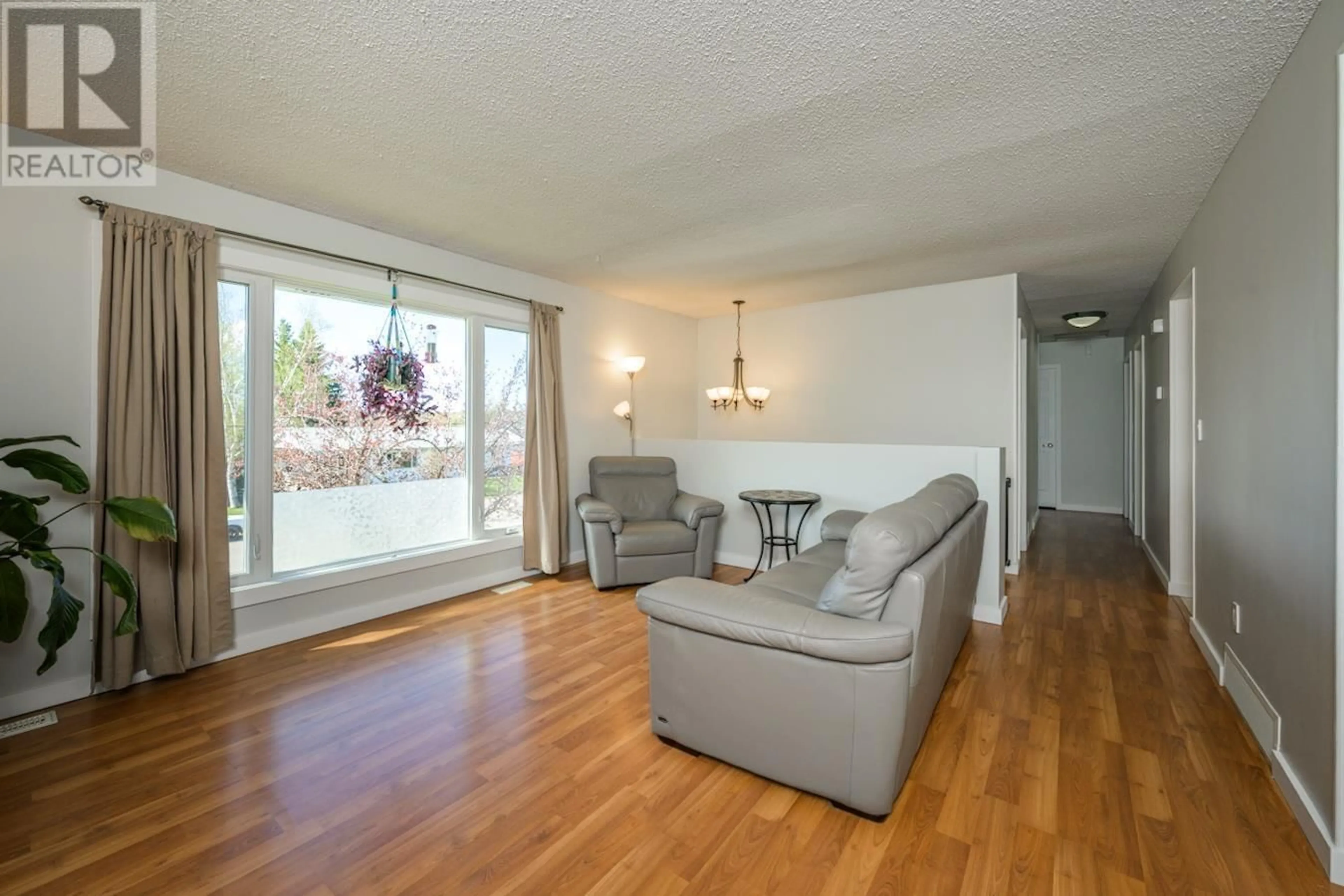 Living room with furniture, wood/laminate floor for 7410 THOMPSON DRIVE, Prince George British Columbia V2N5N5