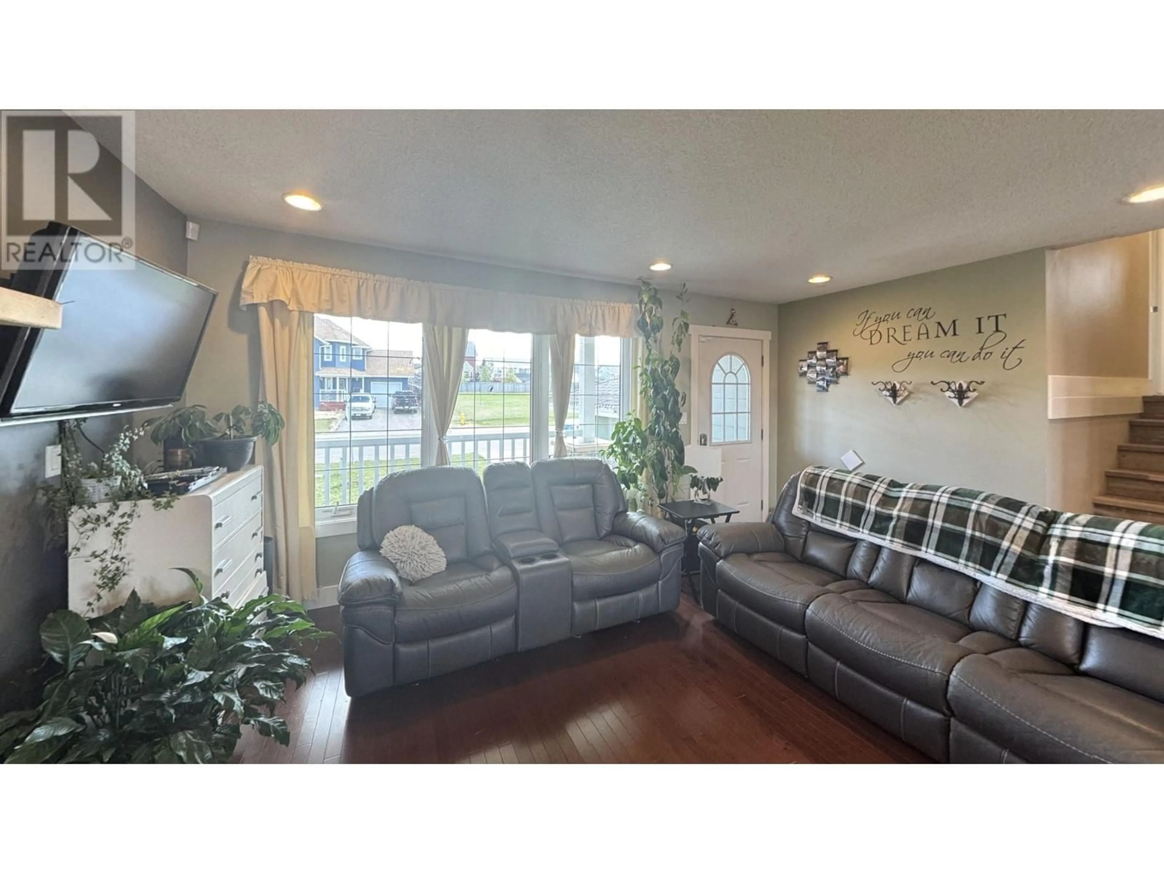 Living room with furniture, wood/laminate floor for 8720 114 AVENUE, Fort St. John British Columbia V1J0C3