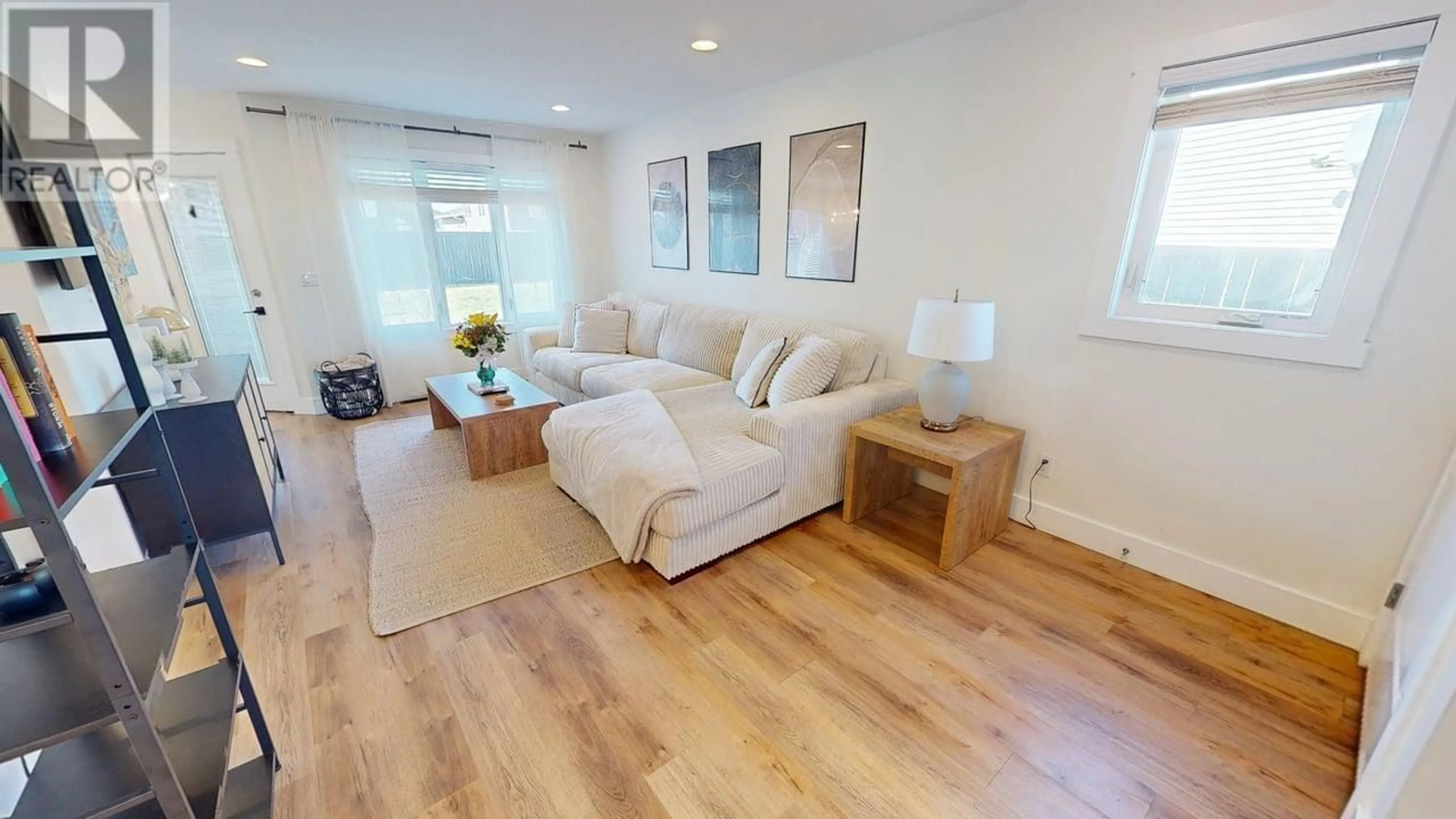Living room with furniture, wood/laminate floor for 8821 113 AVENUE, Fort St. John British Columbia V1J0E2