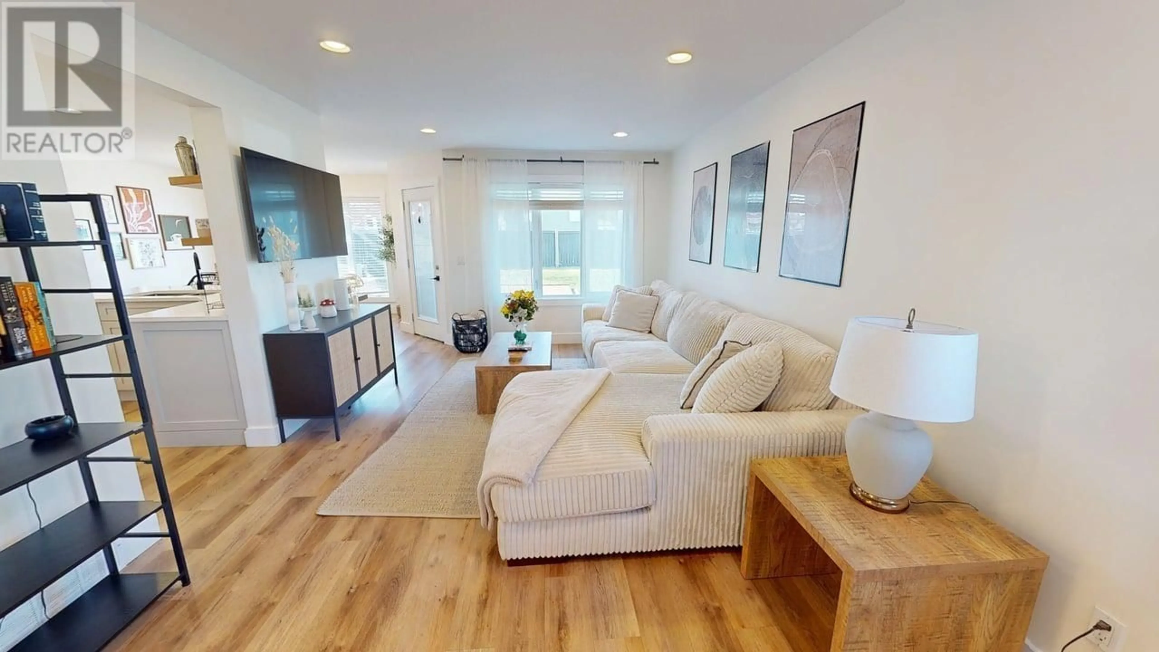 Living room with furniture, wood/laminate floor for 8821 113 AVENUE, Fort St. John British Columbia V1J0E2