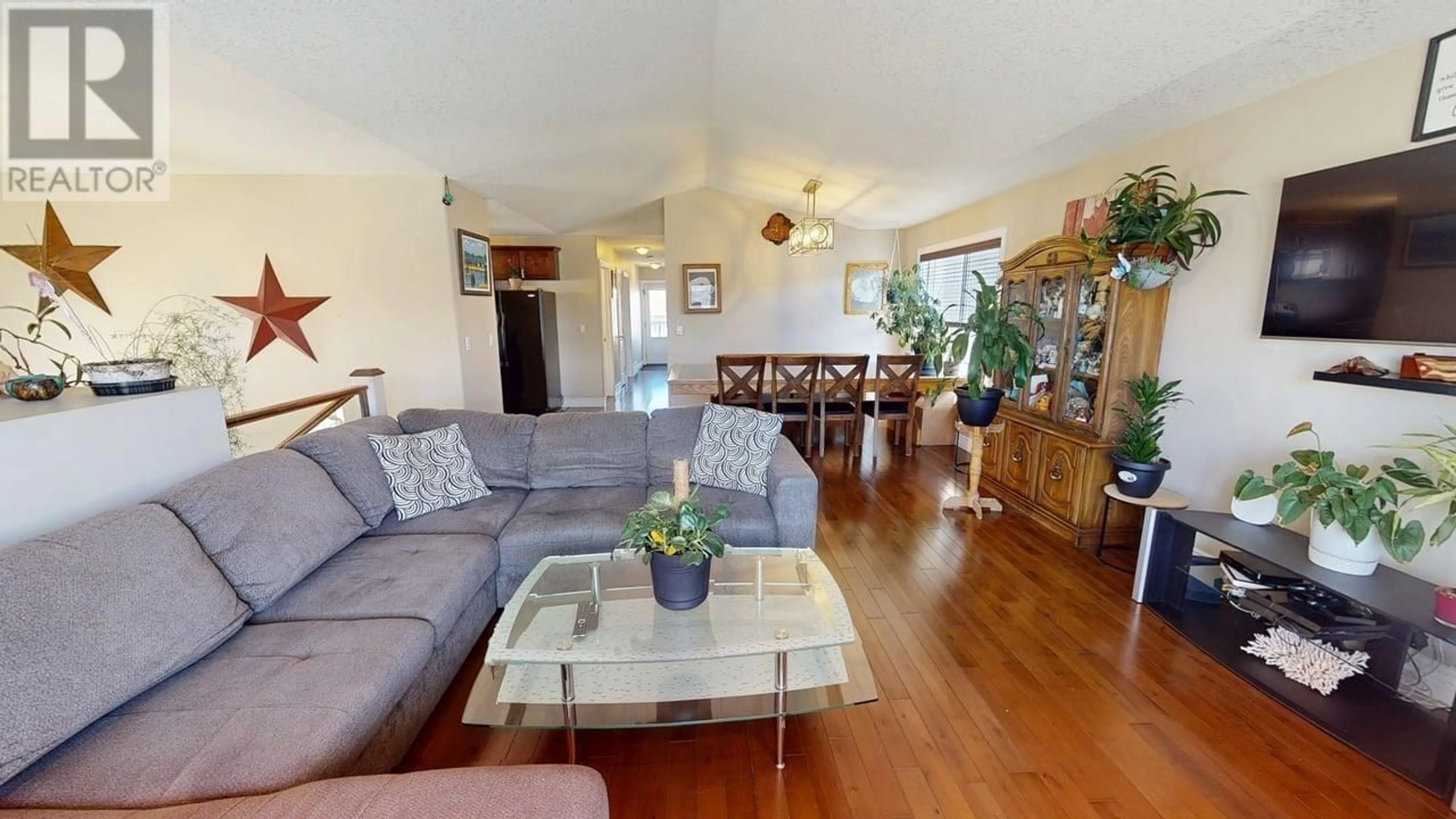 Living room with furniture, wood/laminate floor for 8808 113 AVENUE, Fort St. John British Columbia V1J0E2