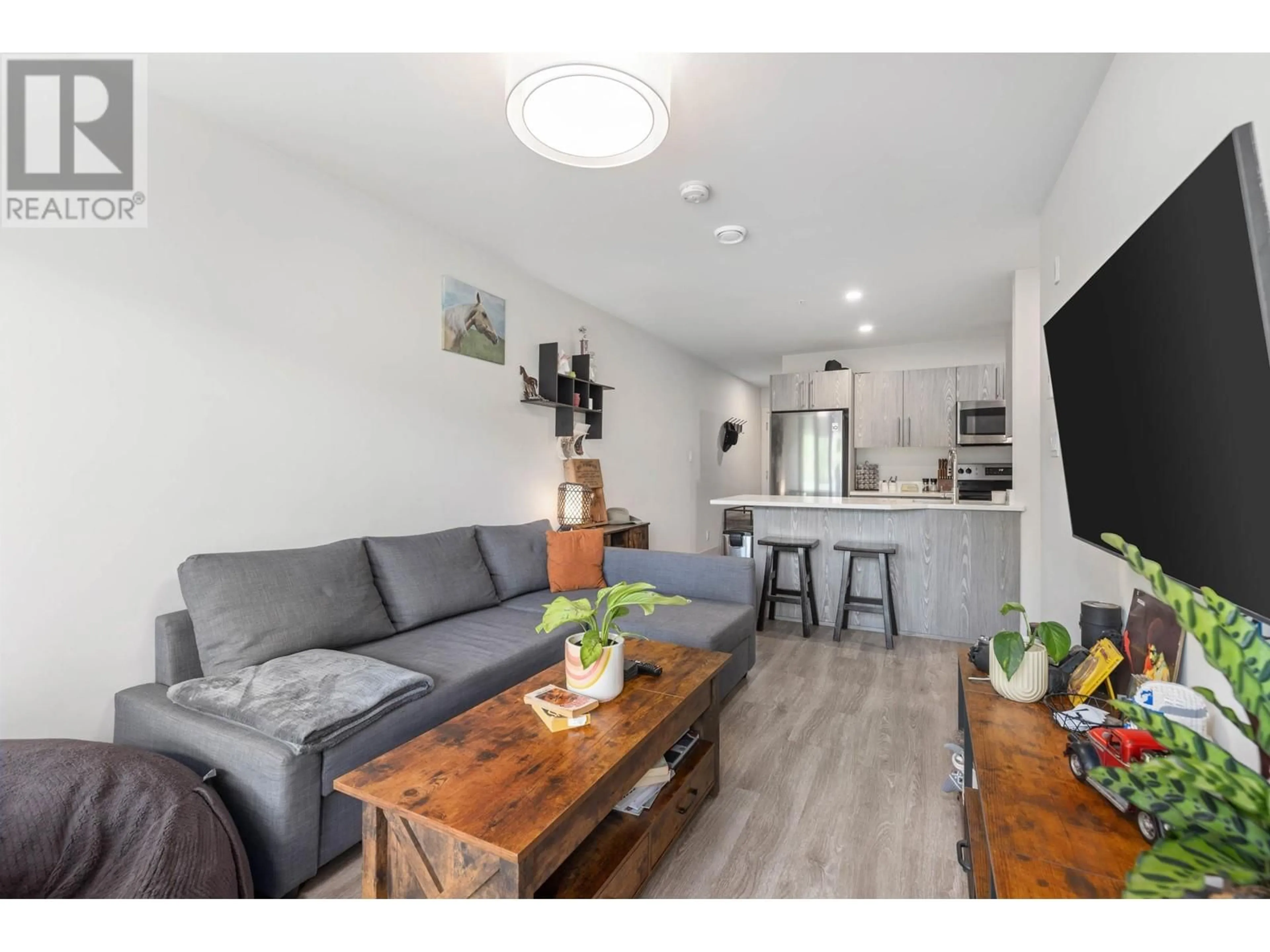 Living room with furniture, wood/laminate floor for 108 - 7350 CRABAPPLE COURT, Pemberton British Columbia V0N2L1