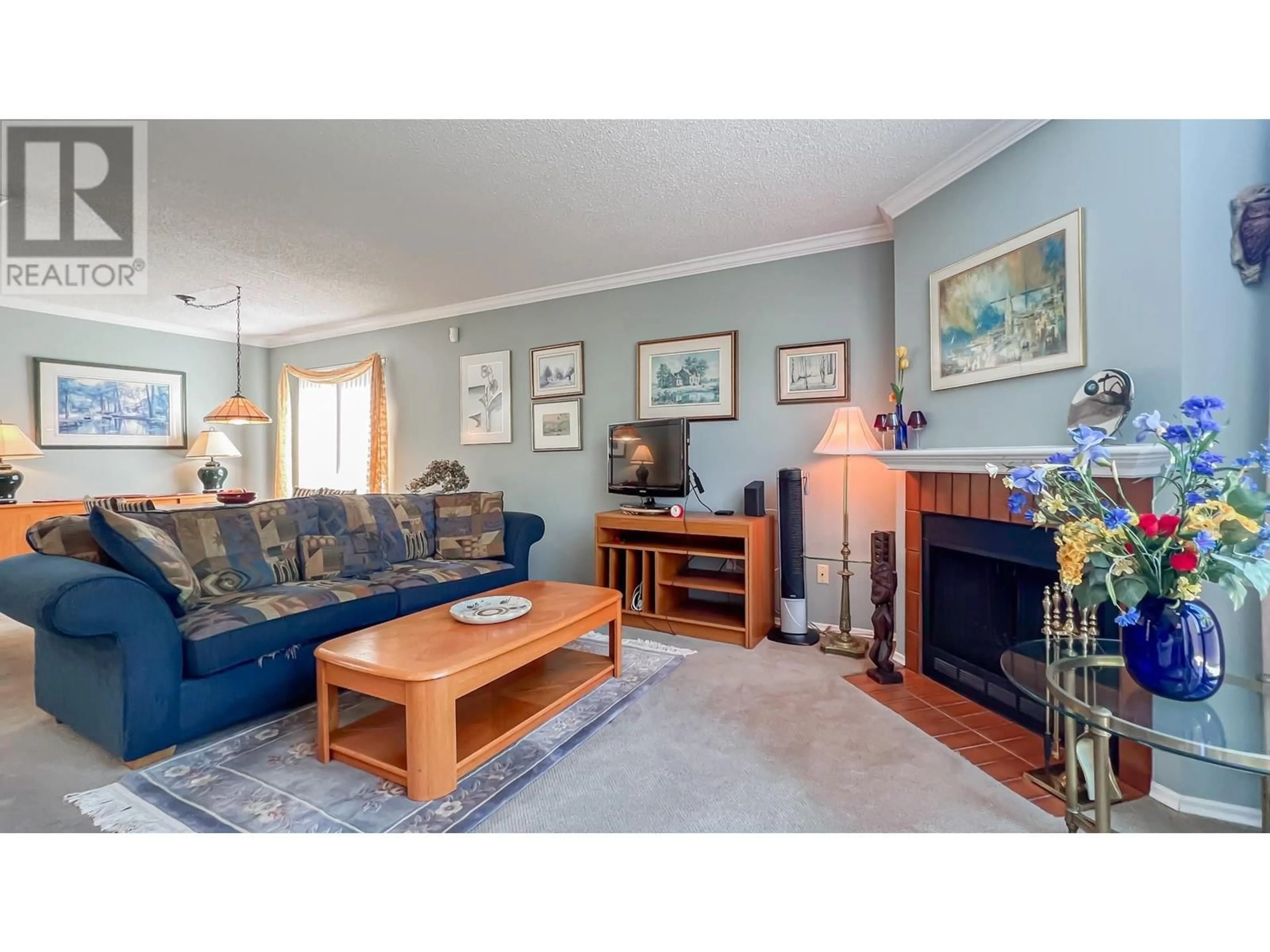 Living room with furniture, wood/laminate floor for 203 - 7300 MOFFATT ROAD, Richmond British Columbia V6Y1X8