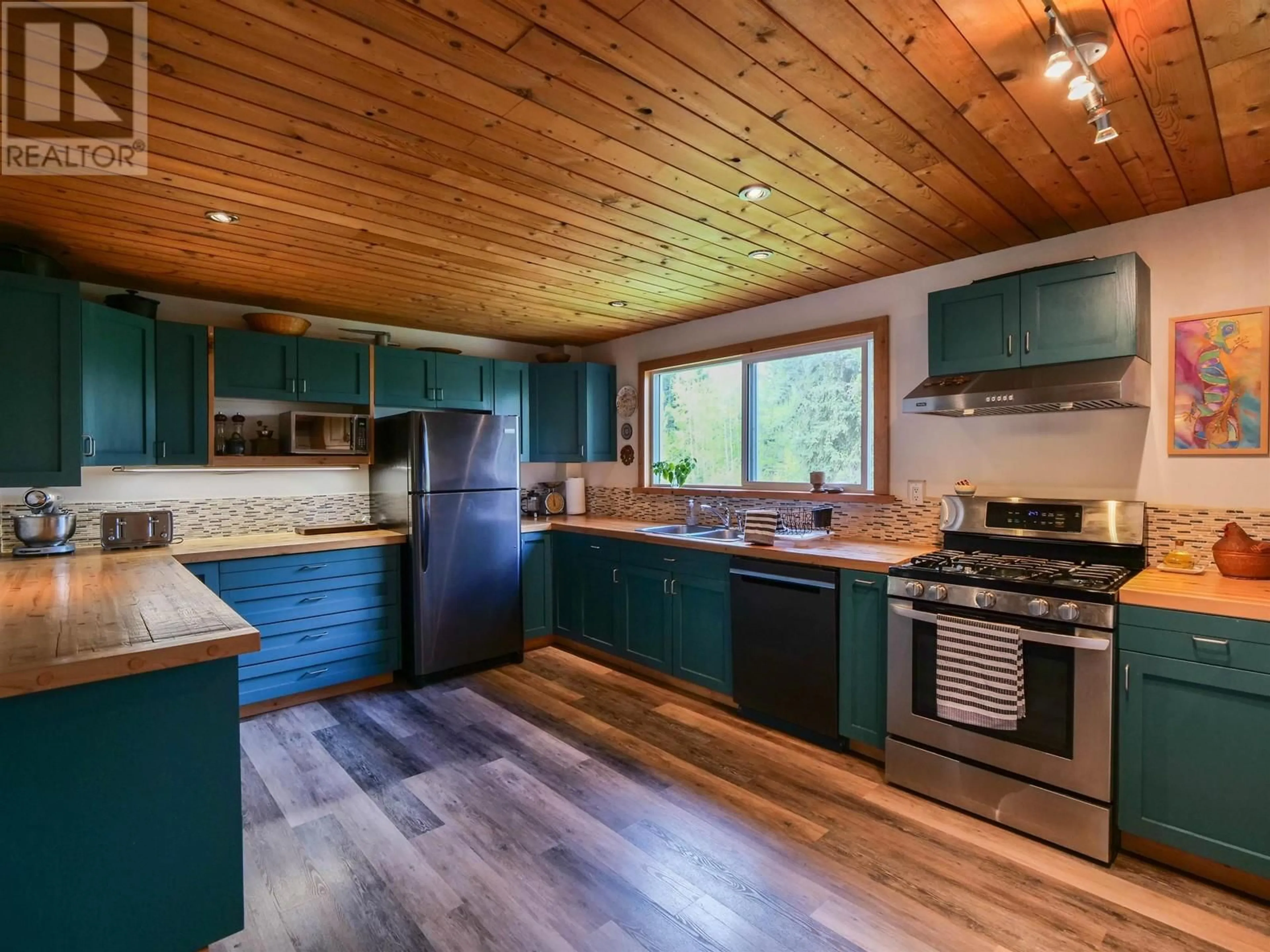 Open concept kitchen, wood/laminate floor for 1974 HIGDON ROAD, Quesnel British Columbia V2J6J6