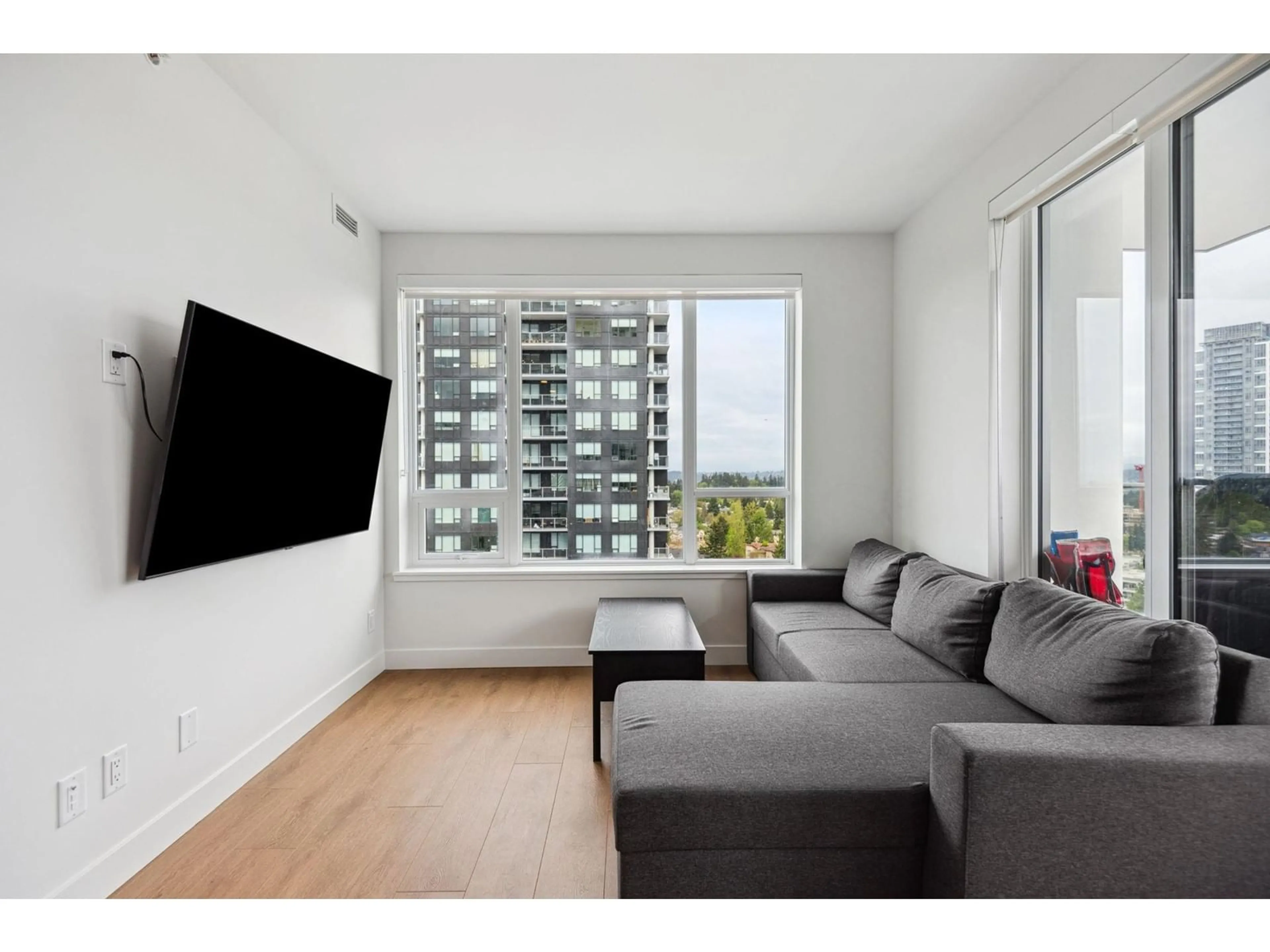 Living room with furniture, wood/laminate floor for 1709 - 13387 OLD YALE, Surrey British Columbia V3T0S4