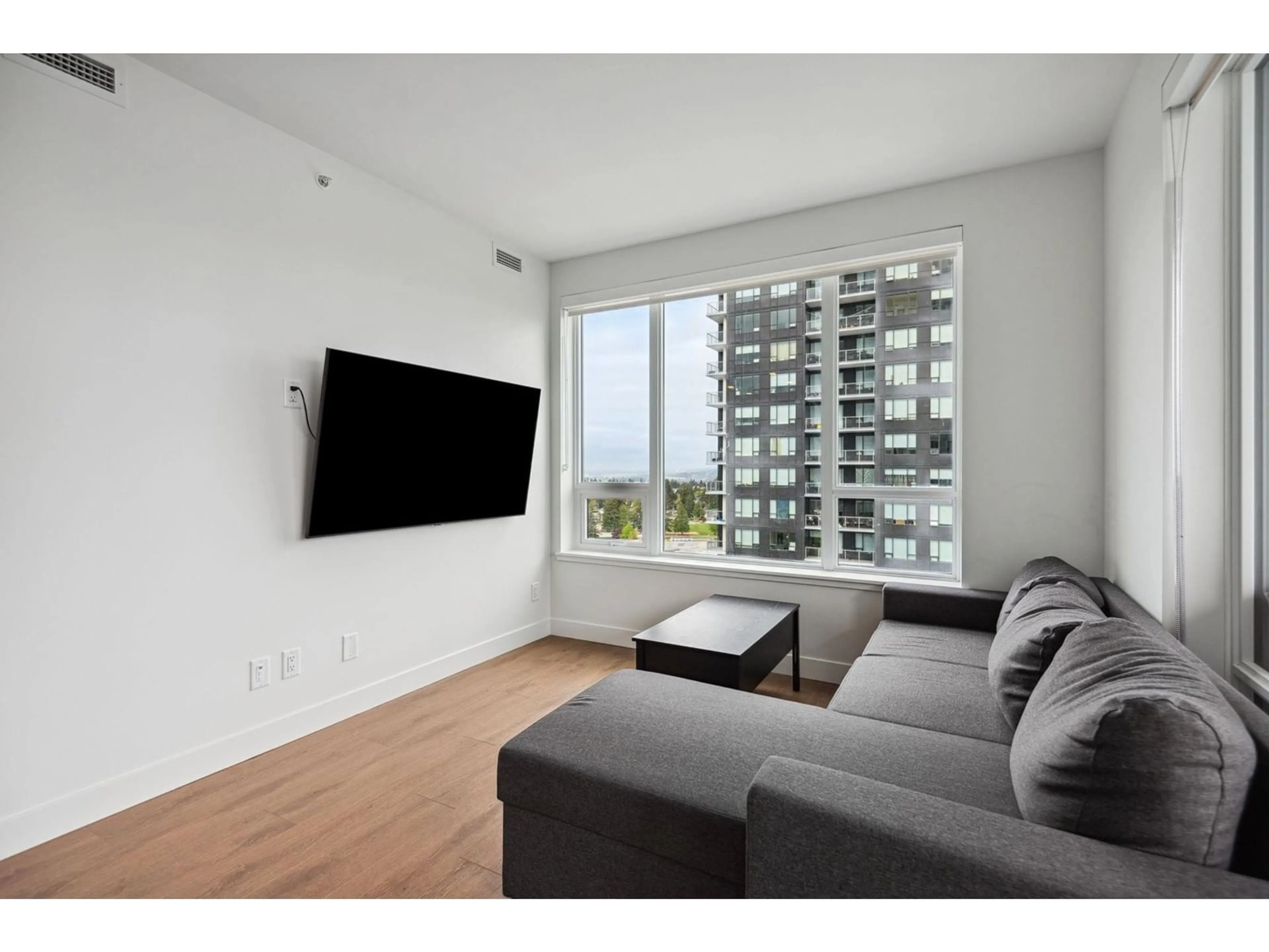 Living room with furniture, wood/laminate floor for 1709 - 13387 OLD YALE, Surrey British Columbia V3T0S4