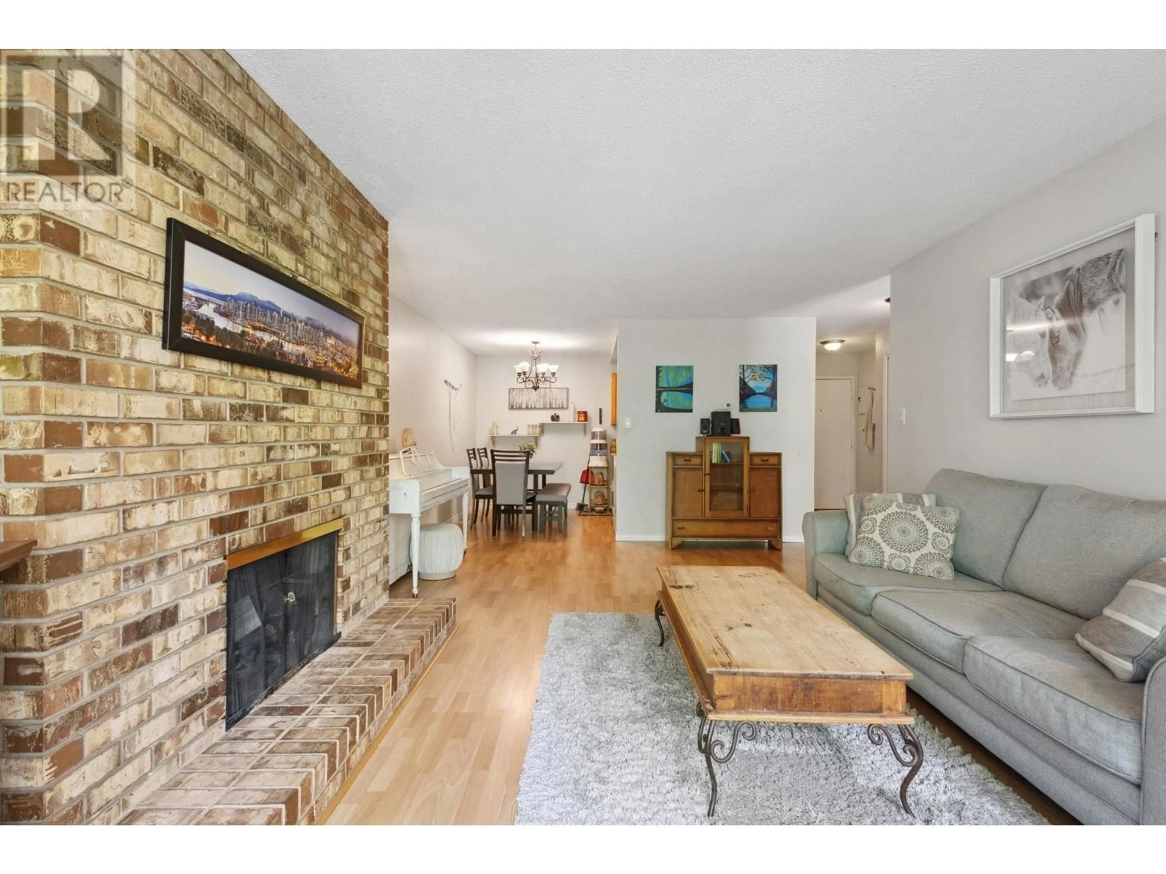 Living room with furniture, wood/laminate floor for 306 - 1385 DRAYCOTT ROAD, North Vancouver British Columbia V7J3K9