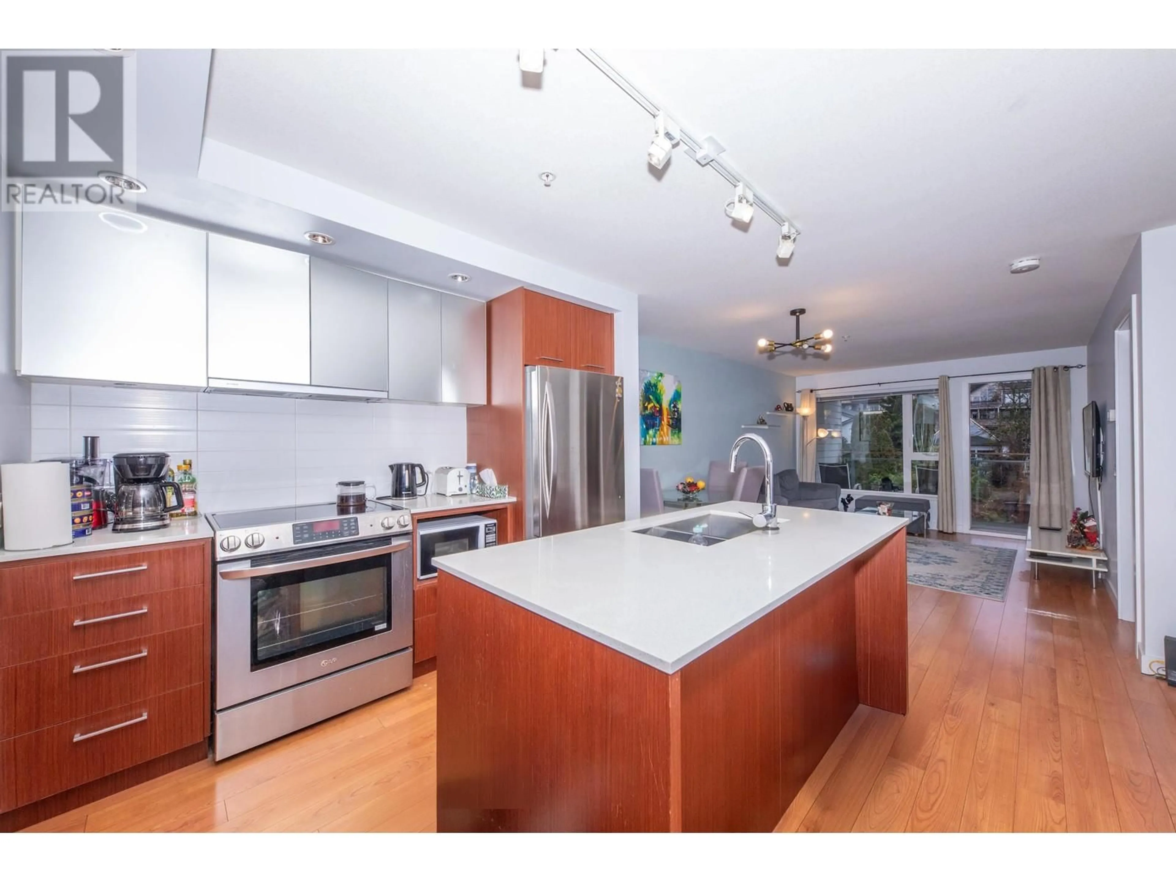 Open concept kitchen, wood/laminate floor for 414 - 221 3RD STREET, North Vancouver British Columbia V7L0C1