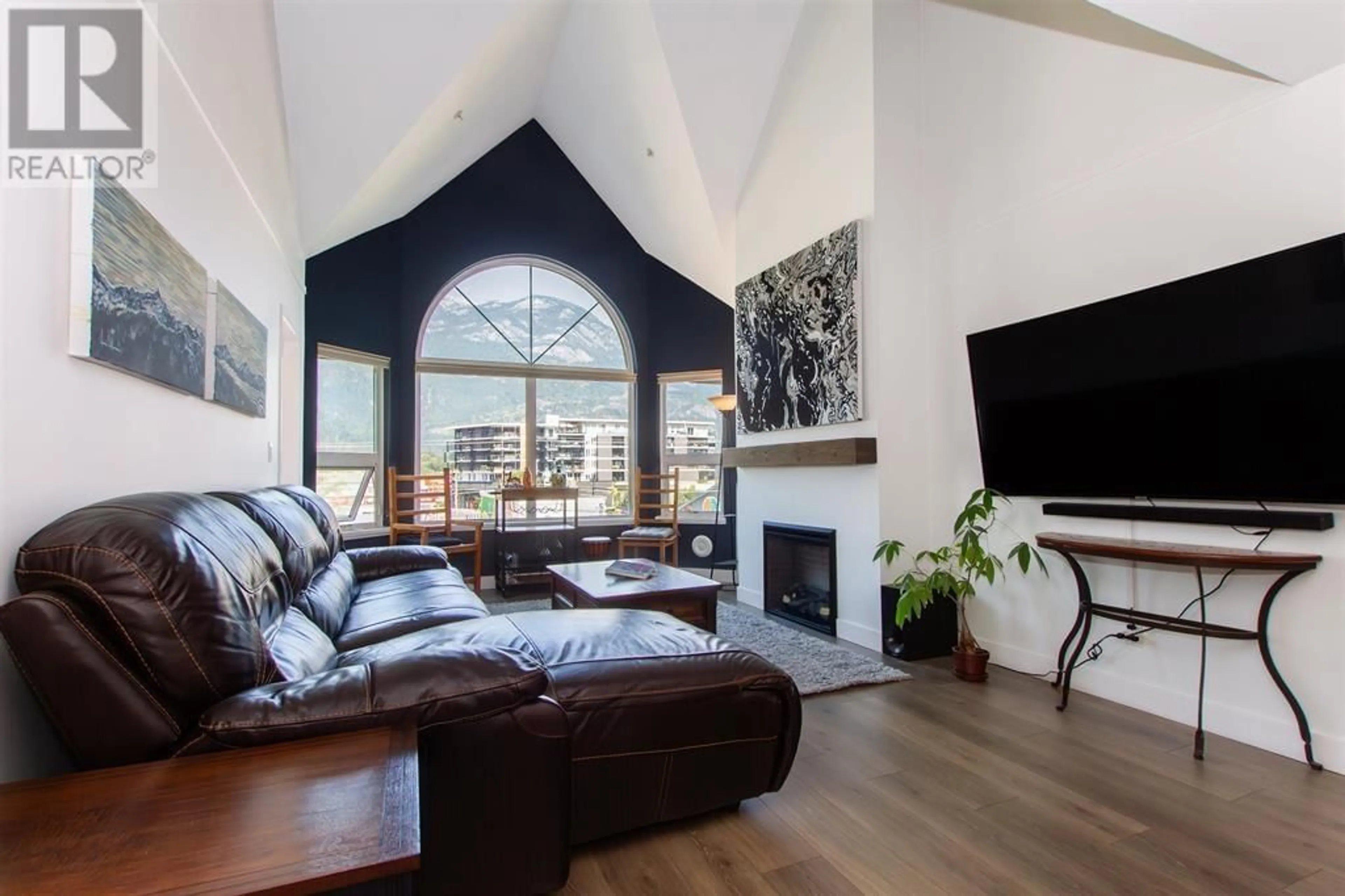 Living room with furniture, wood/laminate floor for 304 - 1466 PEMBERTON AVENUE, Squamish British Columbia V8B0K1