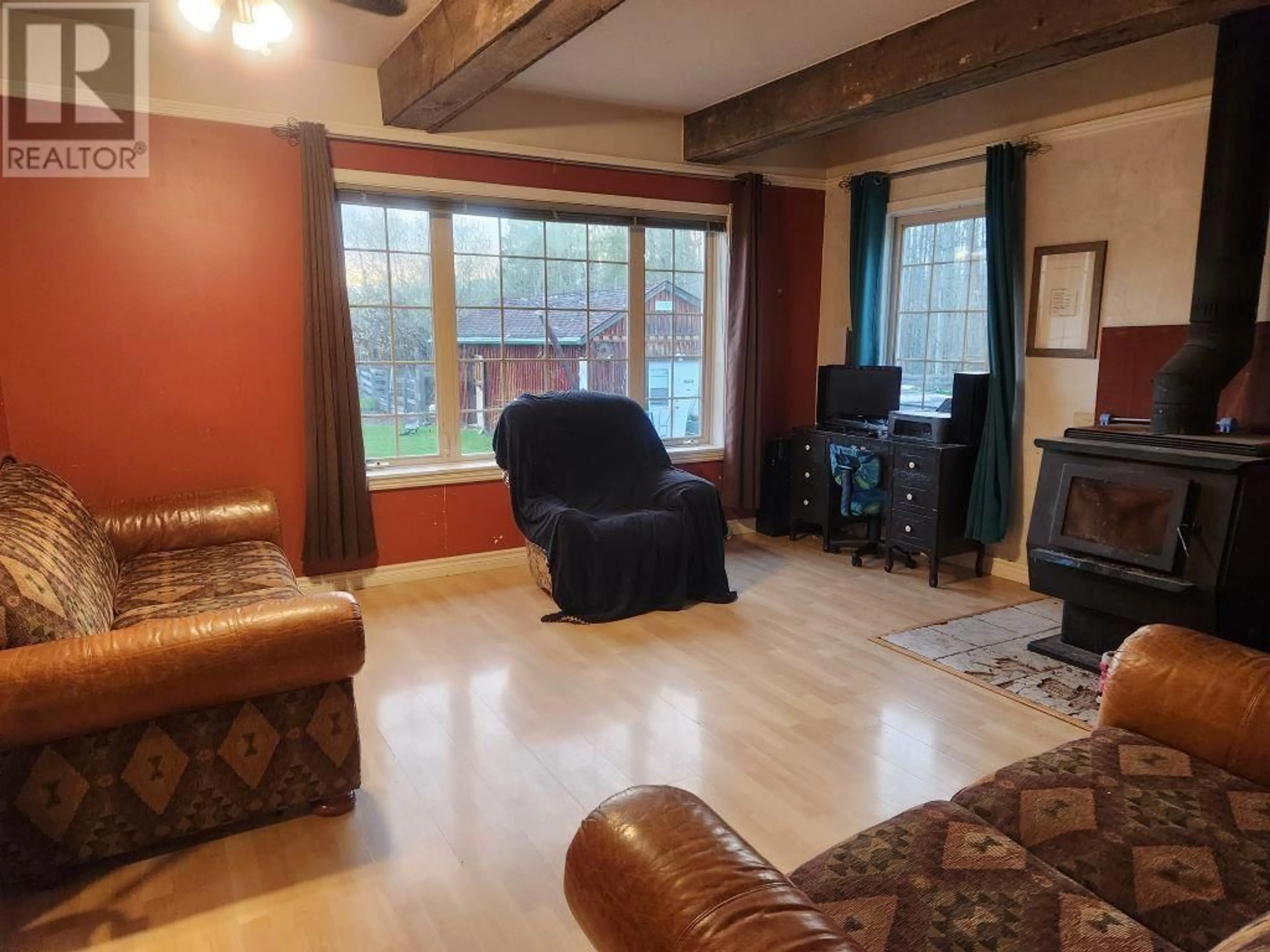 Living room with furniture, wood/laminate floor for 8849 AIRPORT ROAD, Fort St. James British Columbia V0J1P0