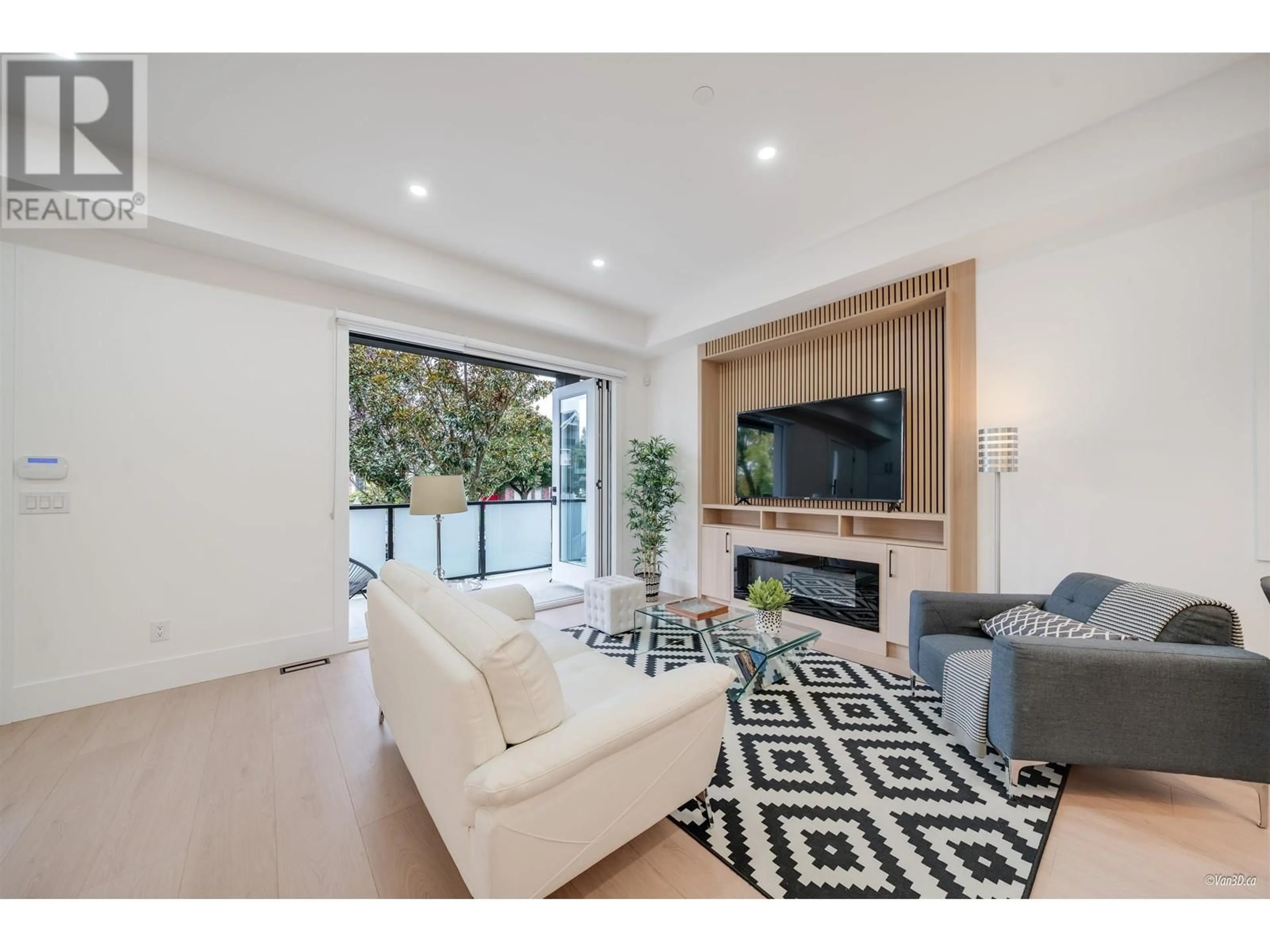 Living room with furniture, wood/laminate floor for 1 - 6964 INVERNESS STREET, Vancouver British Columbia V5X4G5