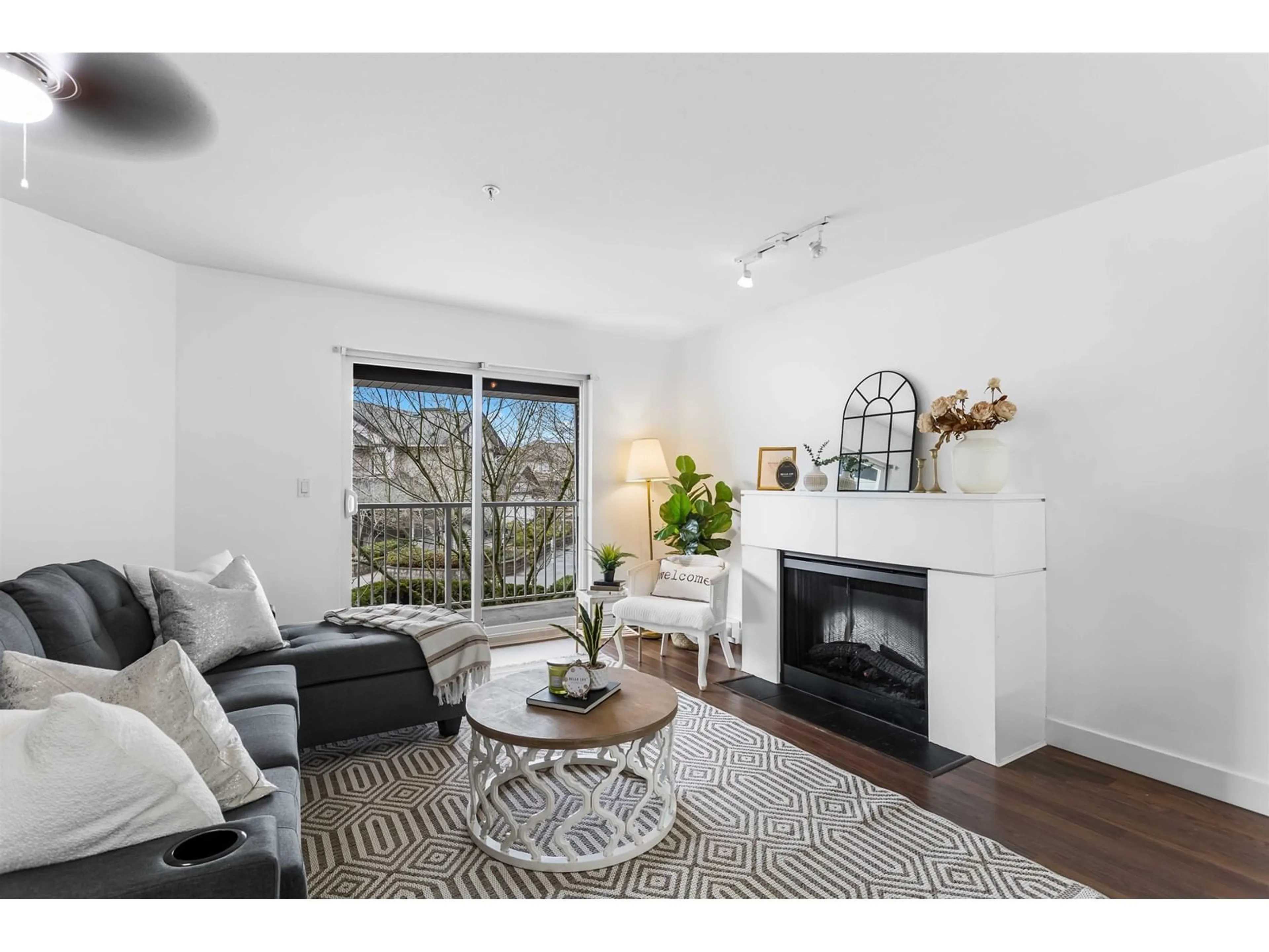 Living room with furniture, wood/laminate floor for 211 - 19340 65, Surrey British Columbia V4N0A3