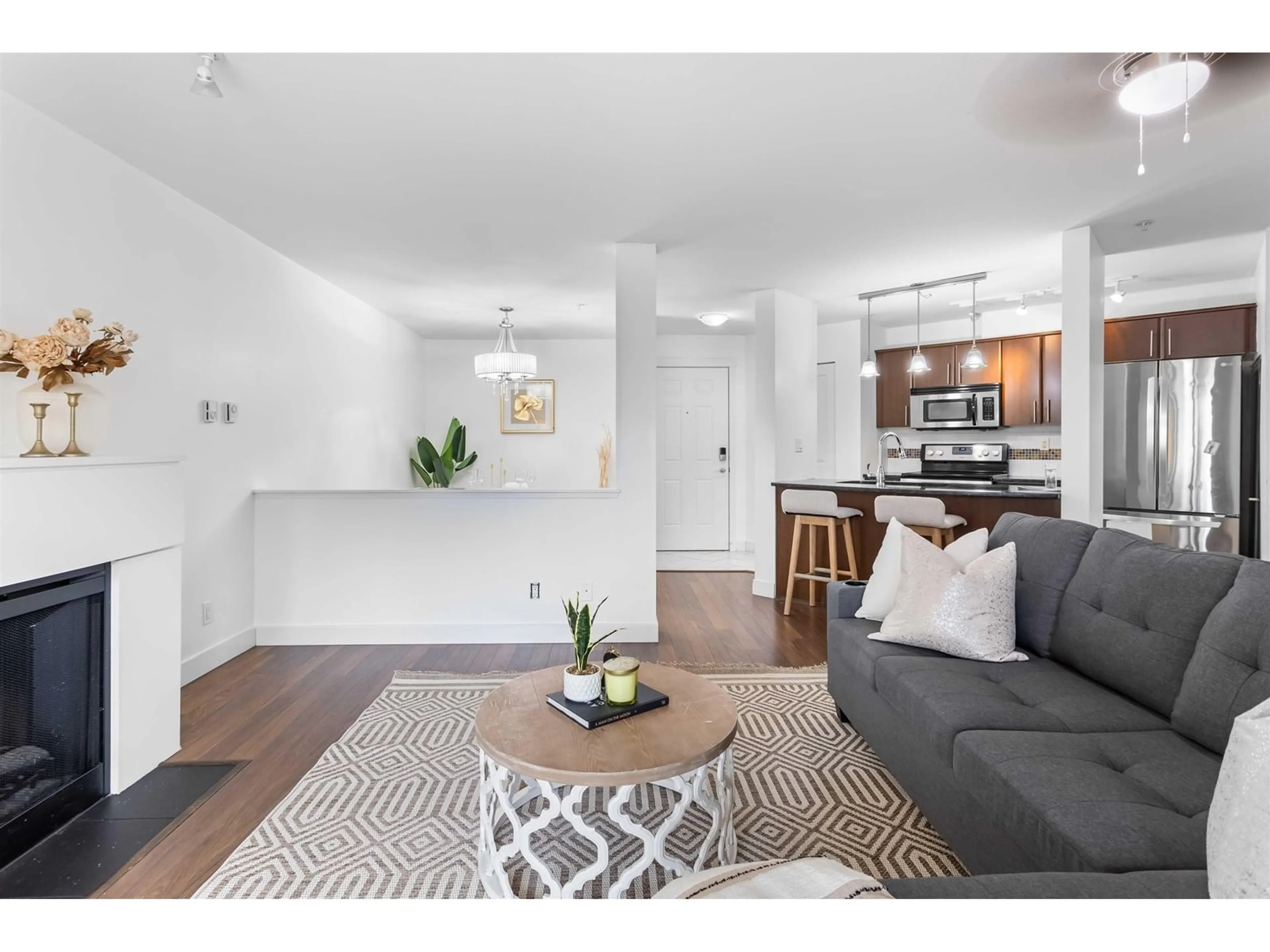 Living room with furniture, wood/laminate floor for 211 - 19340 65, Surrey British Columbia V4N0A3