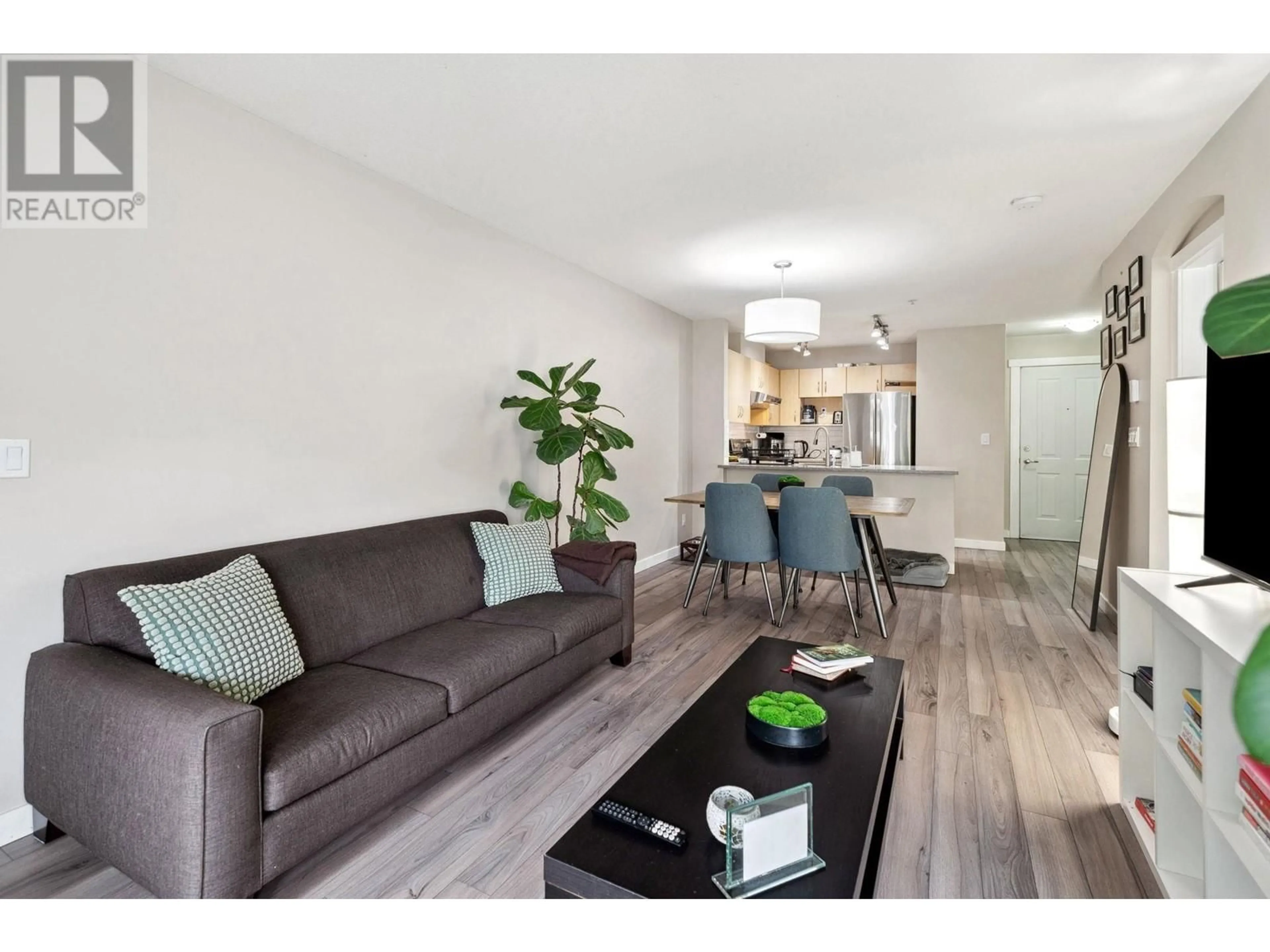 Living room with furniture, wood/laminate floor for 203 - 3038 KENT AVENUE, Vancouver British Columbia V5S4V8