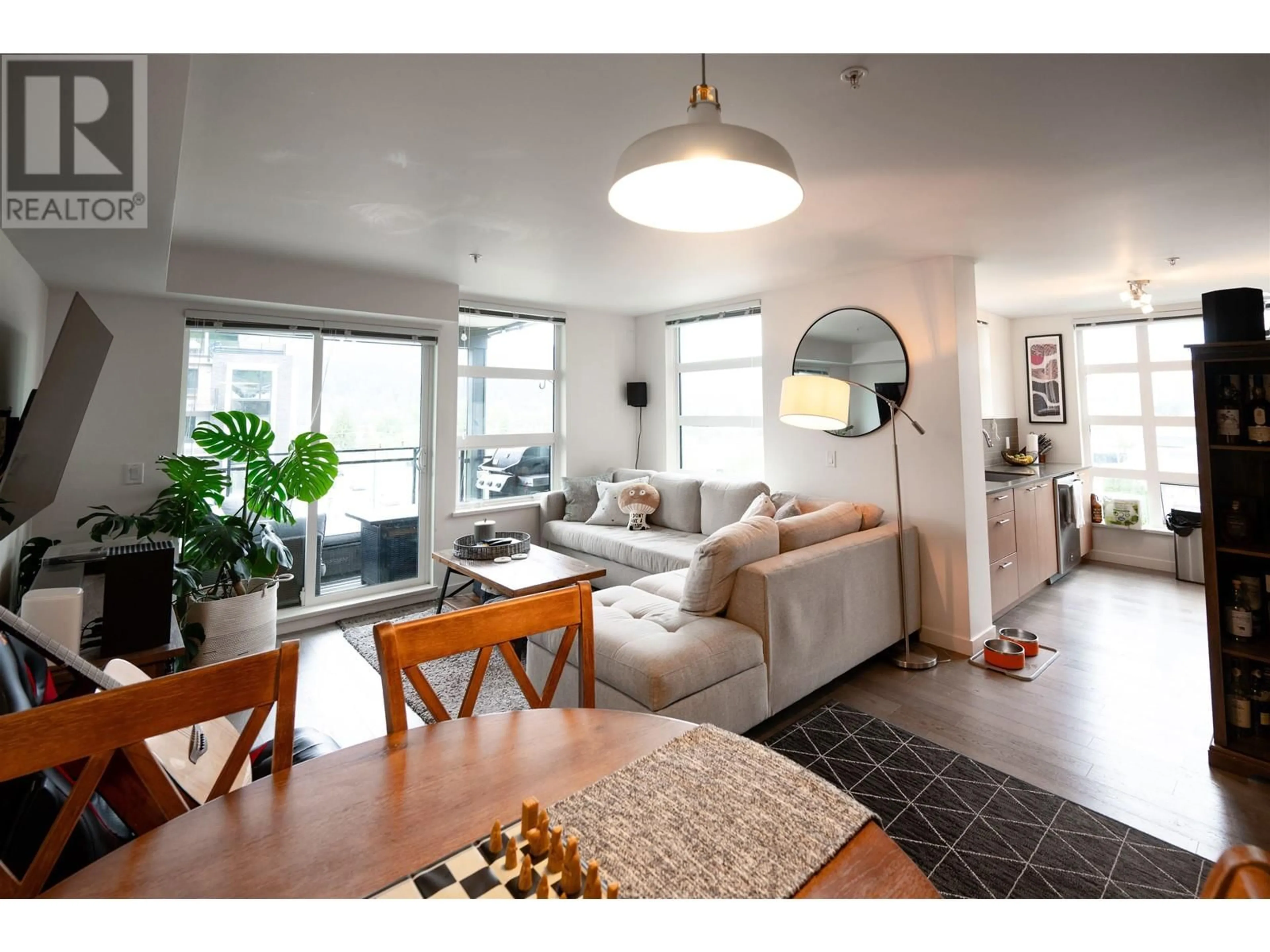 Living room with furniture, wood/laminate floor for 401 - 95 MOODY STREET, Port Moody British Columbia V3H0H2