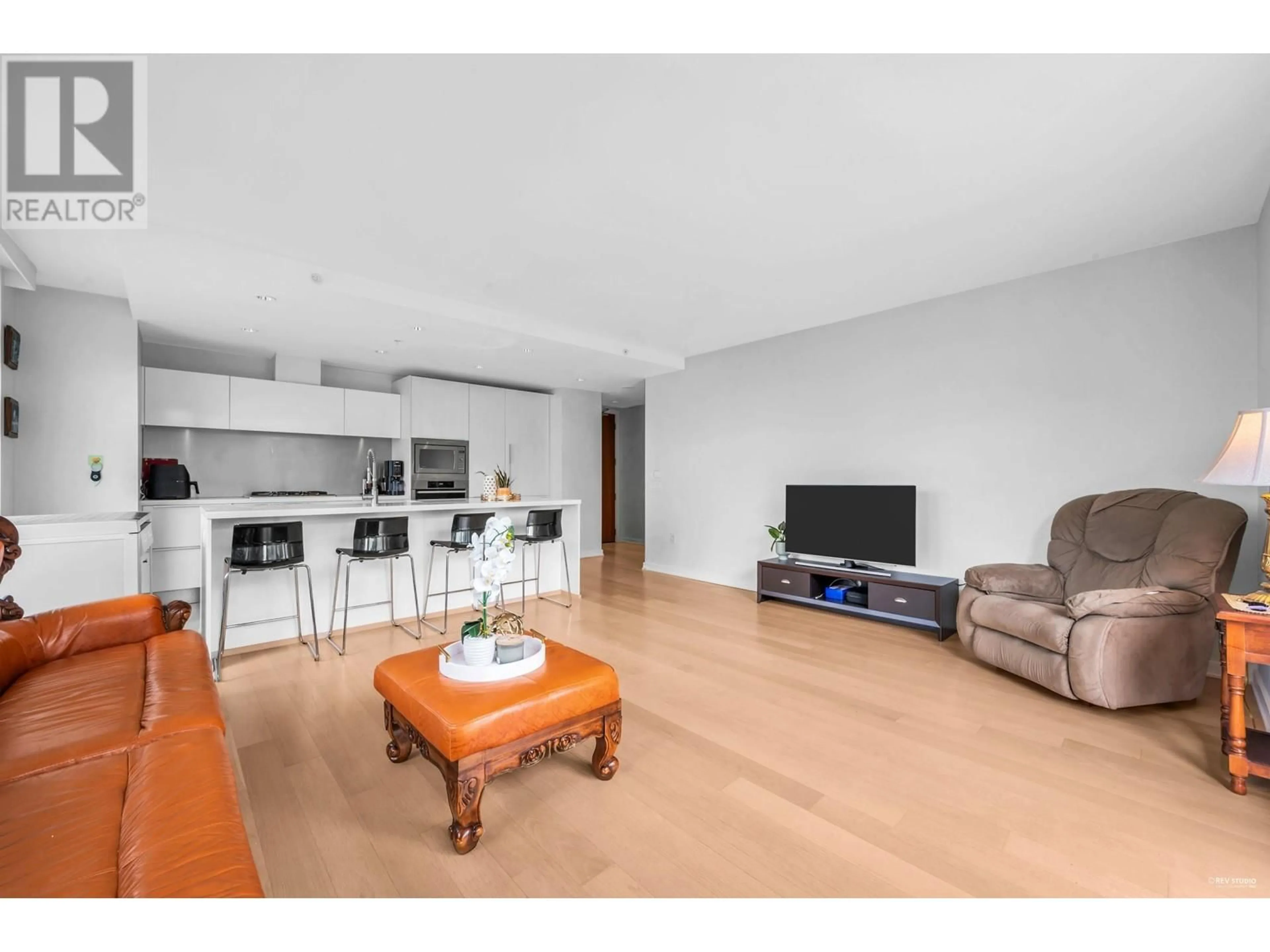 Living room with furniture, wood/laminate floor for 701 - 77 WALTER HARDWICK AVENUE, Vancouver British Columbia V5Y0C6